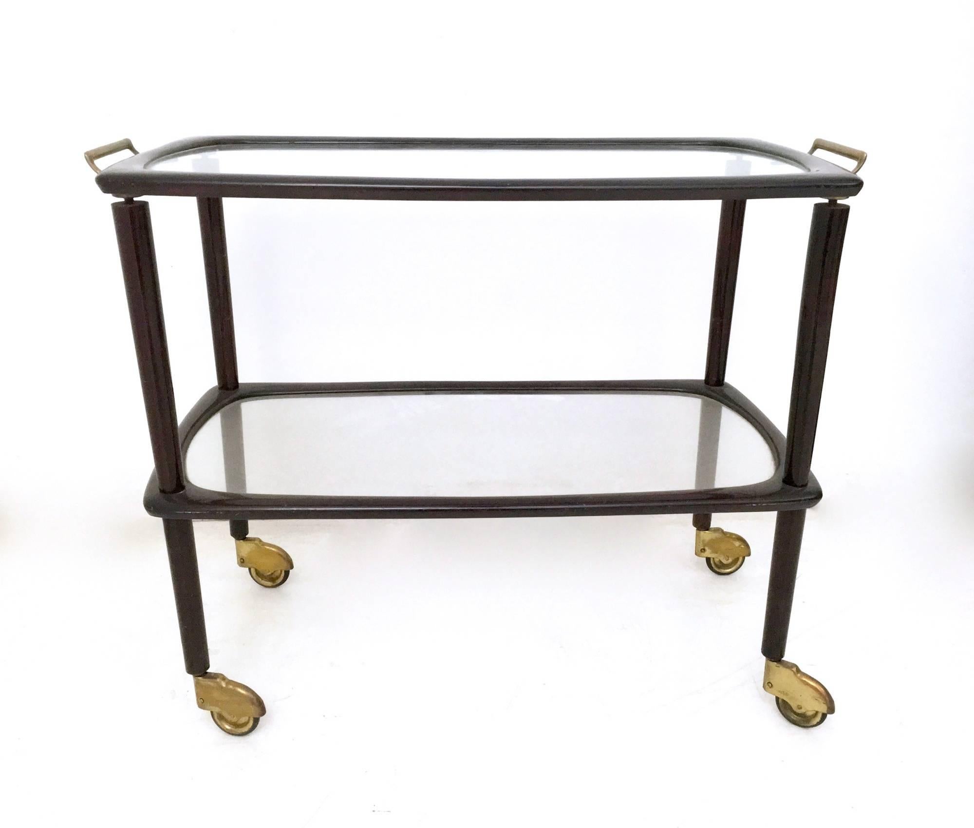 Made in beech, brass and glass.
The top tray can be removed.
In excellent original condition and ready to become a piece in a home.

Measures: Width 83 cm
Depth 40 cm
Height 66 cm.