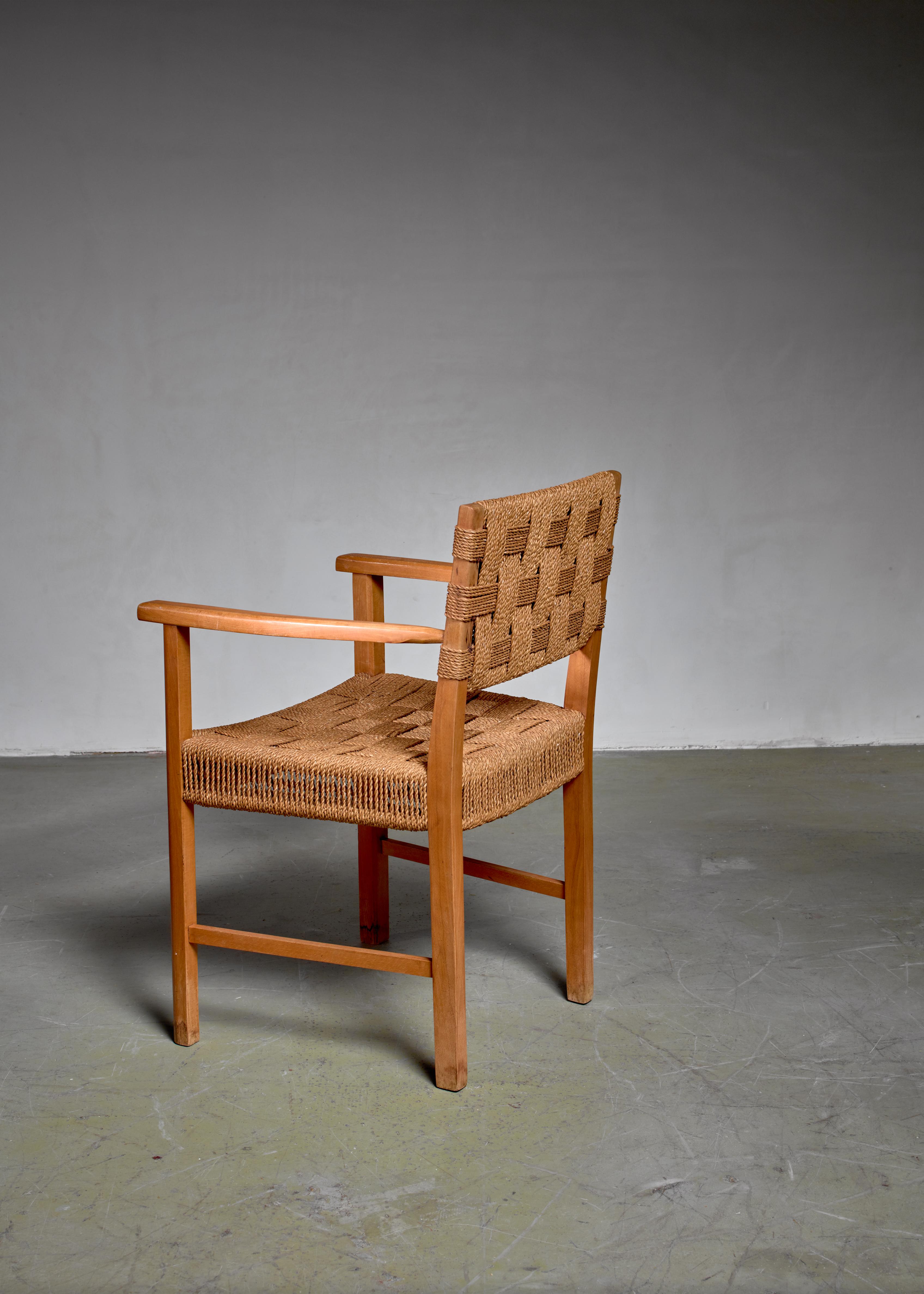 A Danish armchair made of a beech frame with a woven seagrass seating and backrest. The chair and especially the seagrass seating show a strong resemblance to the work of Frits Schlegel.