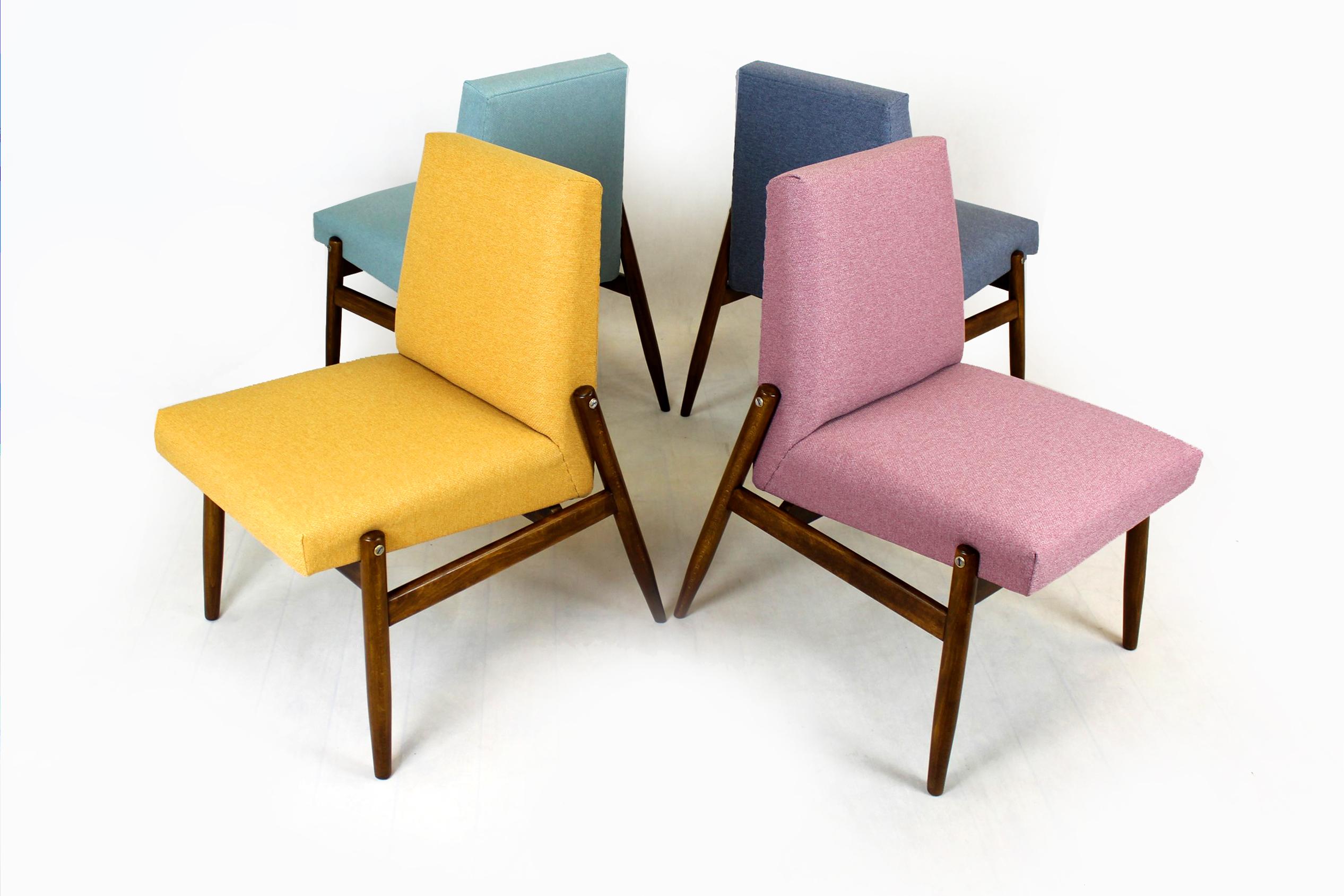 This set of four beech chairs was produced by Zamojskie Fabryki Mebli in the 1960s in Poland. 
The chairs have been restored - lacquered, satin finished wood, new foams upholstered with an easy-to-clean fabric.