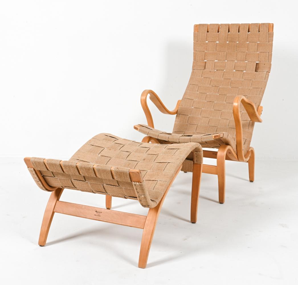 This is an iconic chair and ottoman set known as the 'Eva' model, designed by Bruno Mathsson. This stunning set, both crafted in Sweden in the 1970's, embodies the timeless elegance and functionality of Scandinavian design.

The 'Eva' chair is