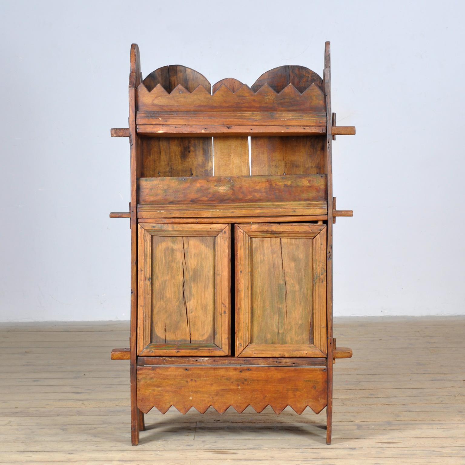 Rustic Wabi Sabi cabinet made of solid beech in Italy, circa 1800. This cabinet offers ample storage space for various items. Two shelves at the front and storage space behind the two doors. Ideal as a hallway cabinet. This piece is in good original