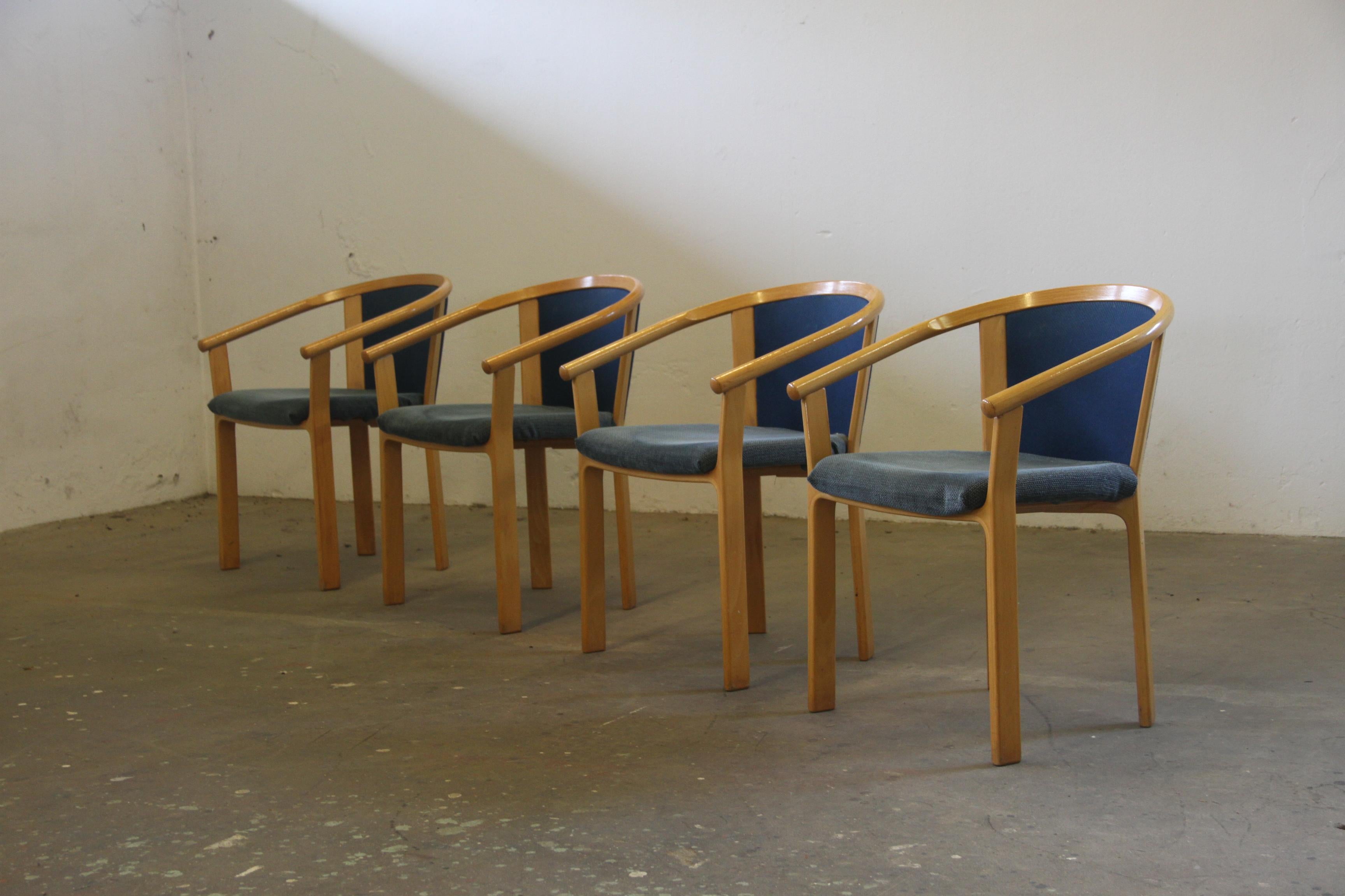 set of four dining chairs in light beech wood bended was designed by Rud Thygesen and Johnny Sørensen and manufactured in Denmark by Magnus Olesen during the 1980s. Each chair features sculpted Beech frame arms with comfortable upholstery and