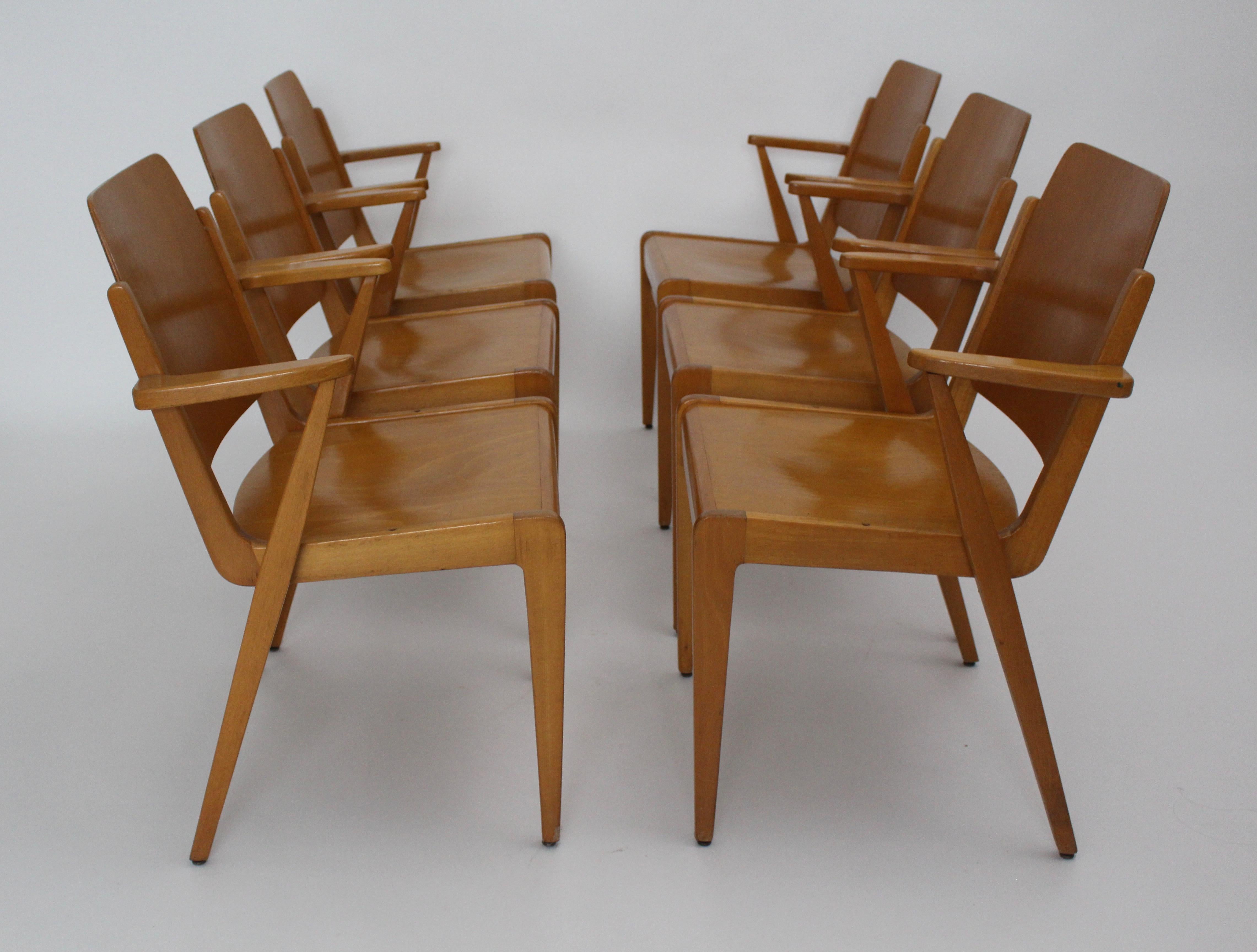 Mid Century Modern set of six dining room chairs model Austro chair with armrests designed by Franz Schuster and executed by Wiesner-Hager (labelled).
These dining room chairs are also stackable.
The materials are solid beechwood and plywood -