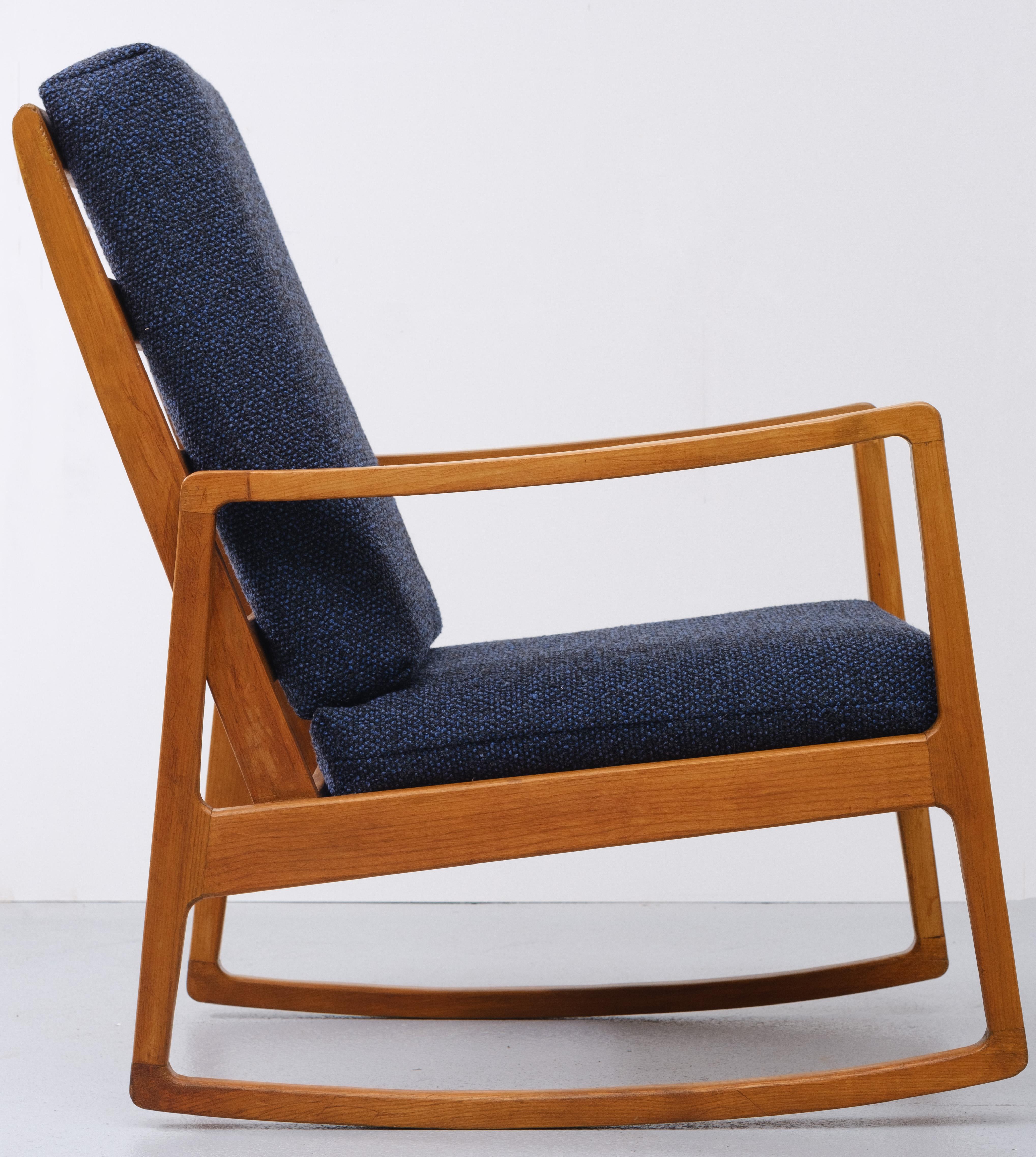 Very nice looking rocking chair. Attributed Ole Wanscher. Beechwood comes with a new dark Blue wool 
upholstery. 1960s Good condition.