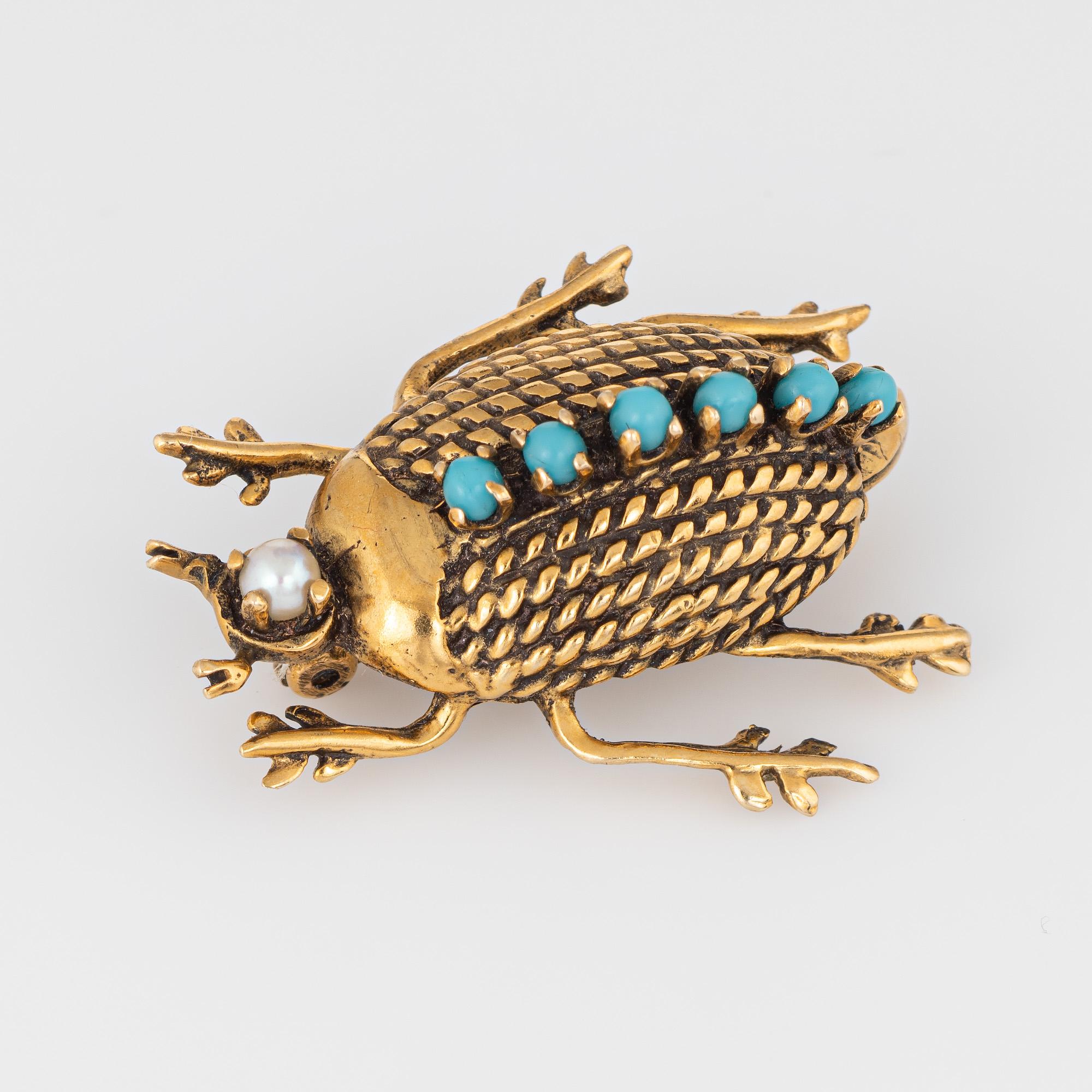 Finely detailed vintage beetle brooch (circa 1950s to 1960s) crafted in 14 karat yellow gold. 

Turquoise cabochons measure 1.5mm each accented with a 2mm cultured pearl. 

The ornate beetle brooch features a rope style design to the center with