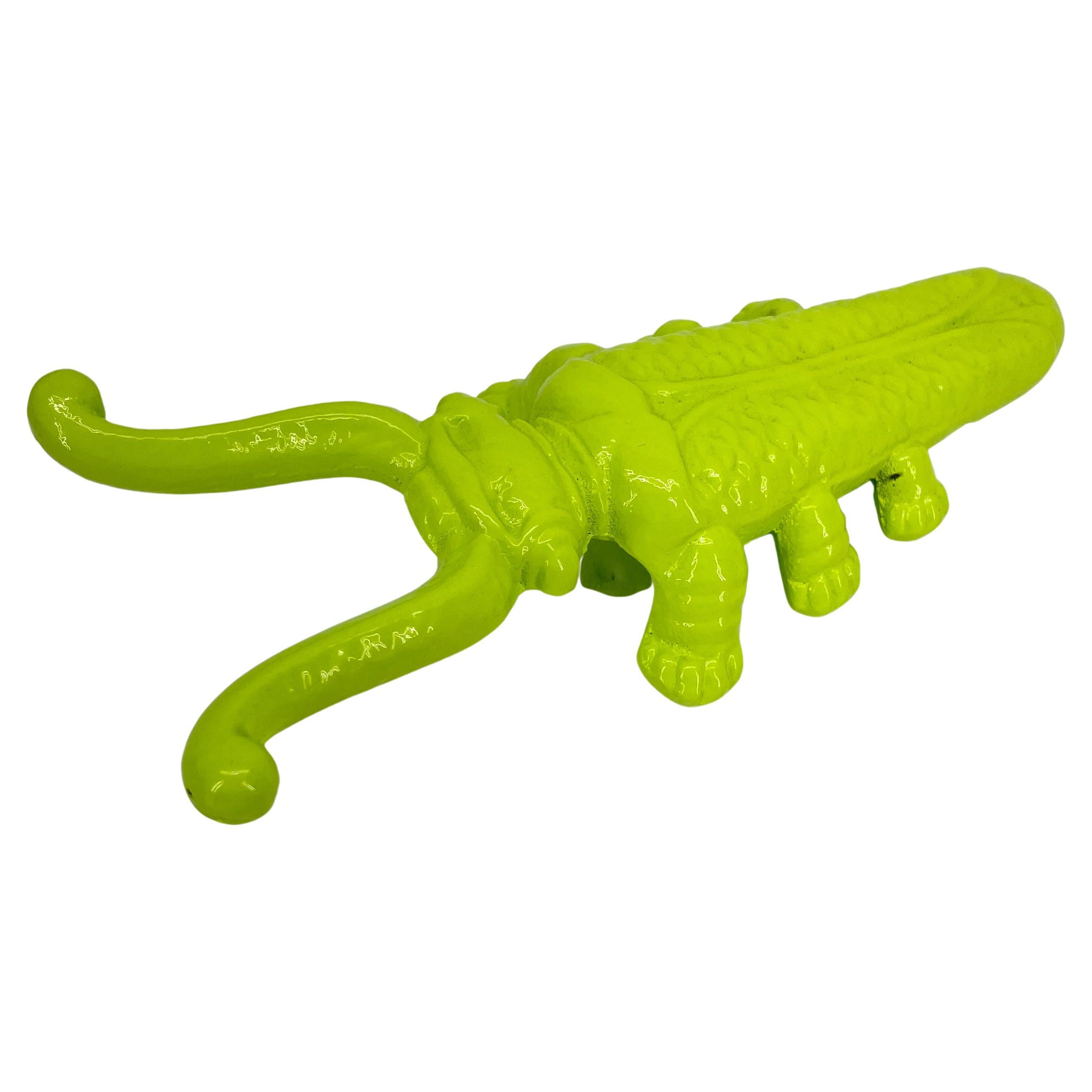 Vintage boot jack in cast iron freshly powder coated in bright chartreuse. The cast iron object is as functional as it is decorative. This bright and fun piece is also perfect as a desk accessory; a paperweight or small sculpture on a bookcase or