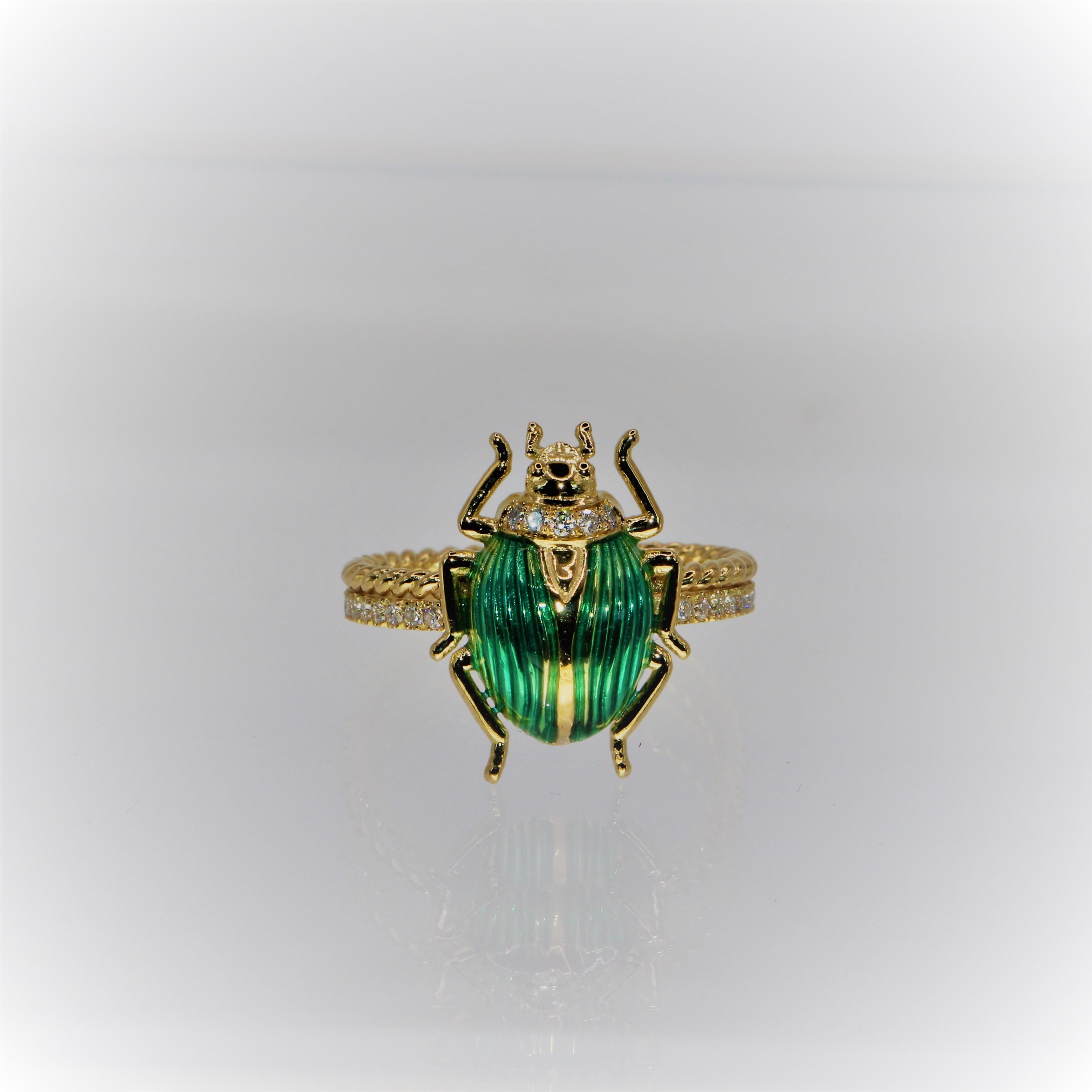 Beetle Ring in 18 carat yellow gold, with granulation technique diamonds  and enamel in green color.
The Diamonds are 0.016ct on the head of the Beetle as also on the base of the ring, A beautiful and detailed work, with enamel in green representing