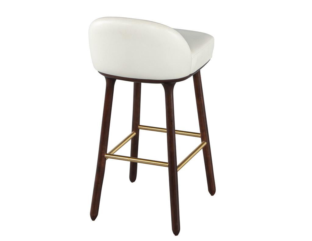 Beetley Bar Stool. Crafted with a sleek and minimalist design, this bar stool exudes a sense of sophistication and elegance. Made with high-quality walnut wood, the Beetley Bar Stool boasts a rich and warm finish that adds a touch of warmth to any