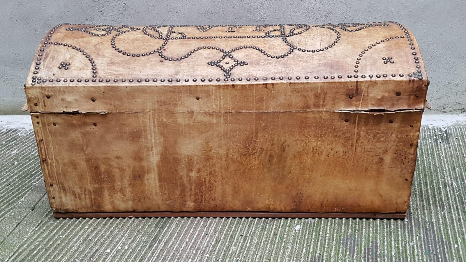 This beautiful and unique trunk comes from Portugal age 1930. It is made by wood and leather and the surface is characterized by upholstery nails which decorates all the trunk and design the initials of the old owner J.J.A. The trunk has some signs