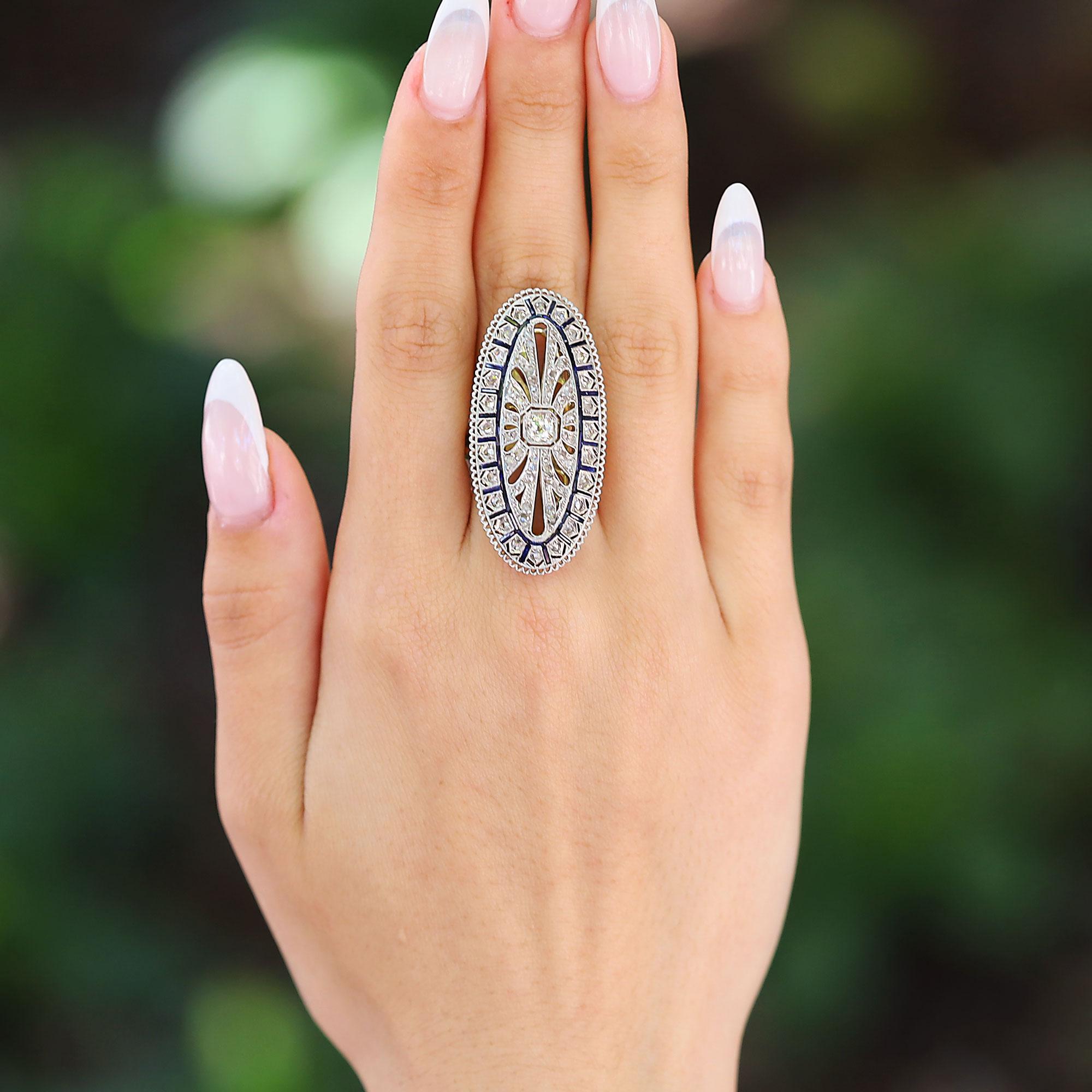 Adorned with fabulous filigree, this ginormous antique Edwardian ring offers maximum finger coverage, sparkling with the luxurious old-world charm of the congruent Belle Epoque era. At over 1 1/2