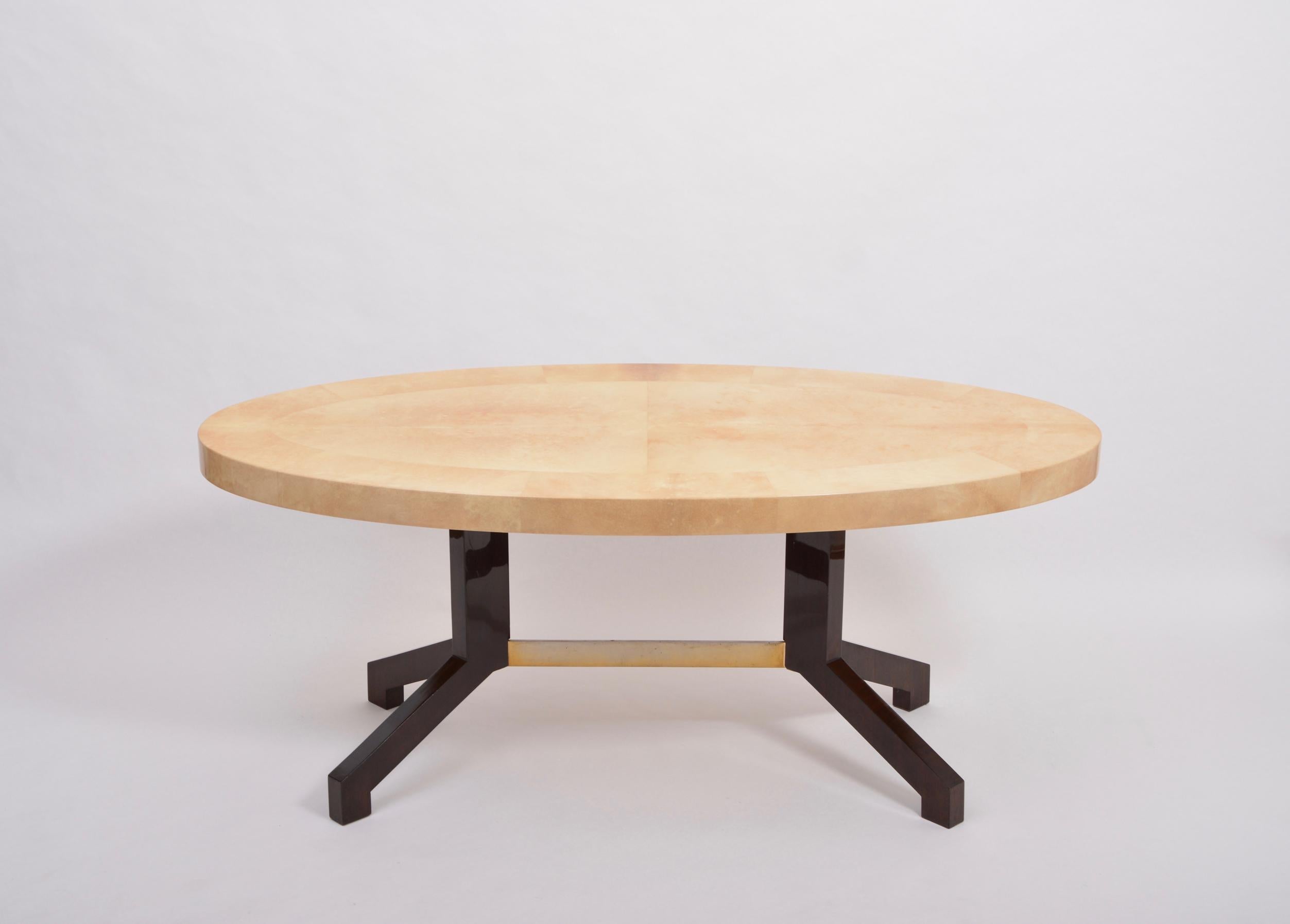 Oval dining table designed by Aldo Tura and produced in Italy in the 1970s. This dining table is a very strong example of his work, simple in form, with a soft curved oval top affixed to two mahogany feet connected with a metal bar. The ethereal