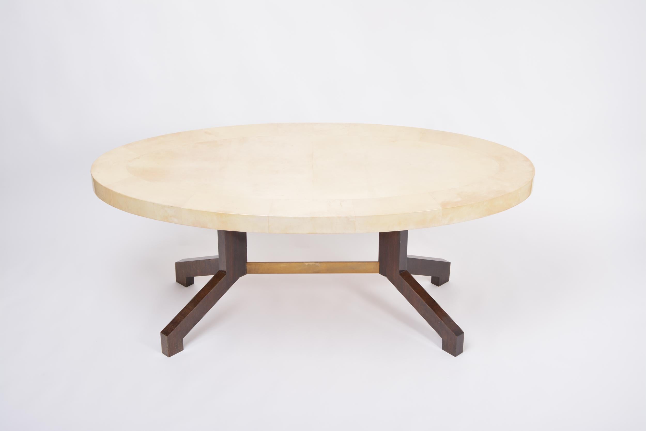 Oval dining table designed by Aldo Tura and produced in Italy in the 1970s. This dining table is a very strong example of his work, simple in form, with a soft curved oval top affixed to two mahogany feet connected with a metal bar. The ethereal