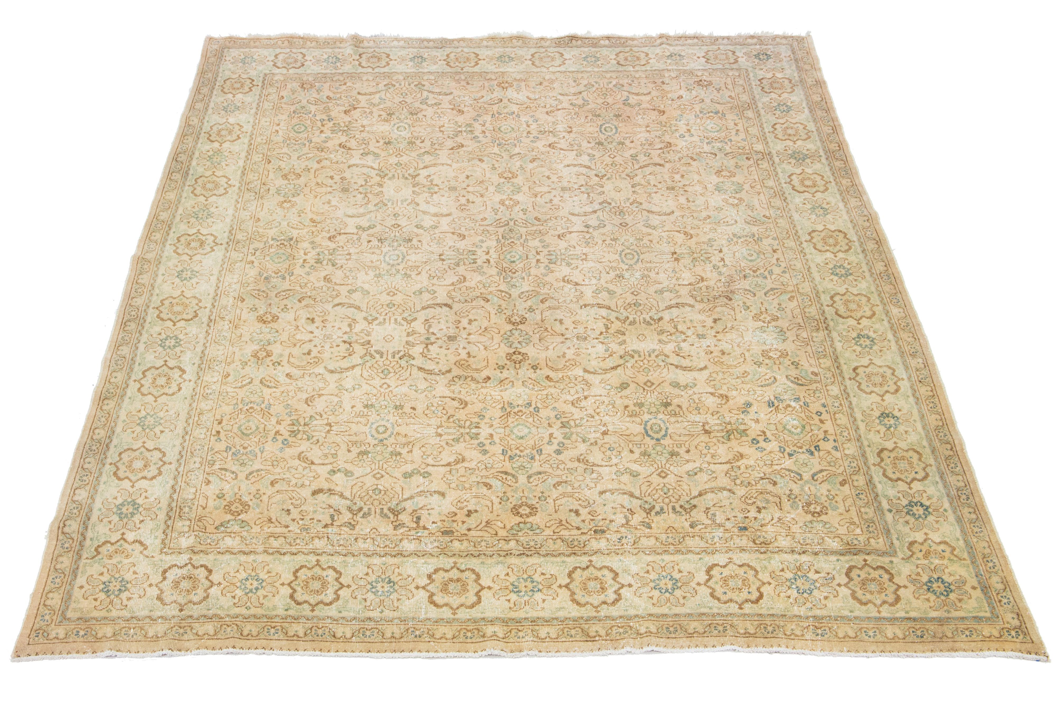 This handcrafted Persian Mahal wool rug showcases a traditional floral pattern. The contrast between the beige backdrop emphasizes the brown and blue floral design.

This rug measures 10'2