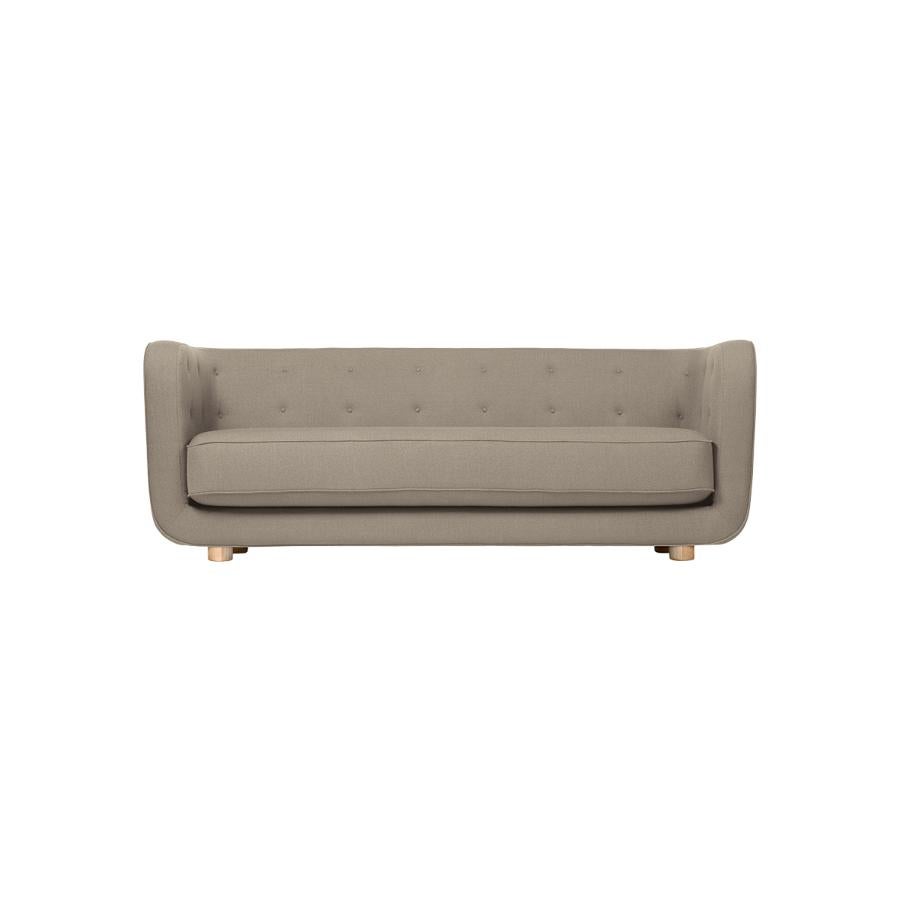 Beige and natural oak Raf Simons Vidar 3 Vilhelm sofa by Lassen
Dimensions: W 217 x D 88 x H 80 cm 
Materials: textile, oak.

Vilhelm is a beautiful padded three-seater sofa designed by Flemming Lassen in 1935. A sofa must be able to function in