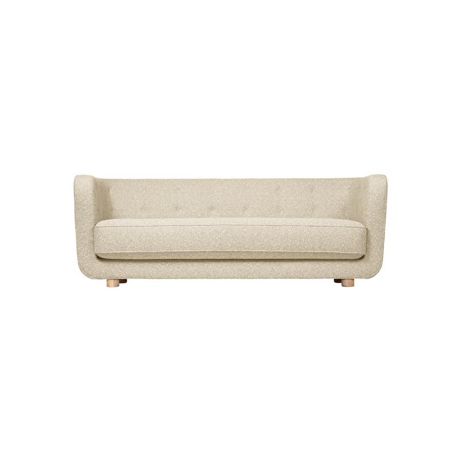 Beige and natural oak Sahco Zero Vilhelm sofa by Lassen.
Dimensions: W 217 x D 88 x H 80 cm. 
Materials: Textile, Oak.

Vilhelm is a beautiful padded three-seater sofa designed by Flemming Lassen in 1935. A sofa must be able to function in