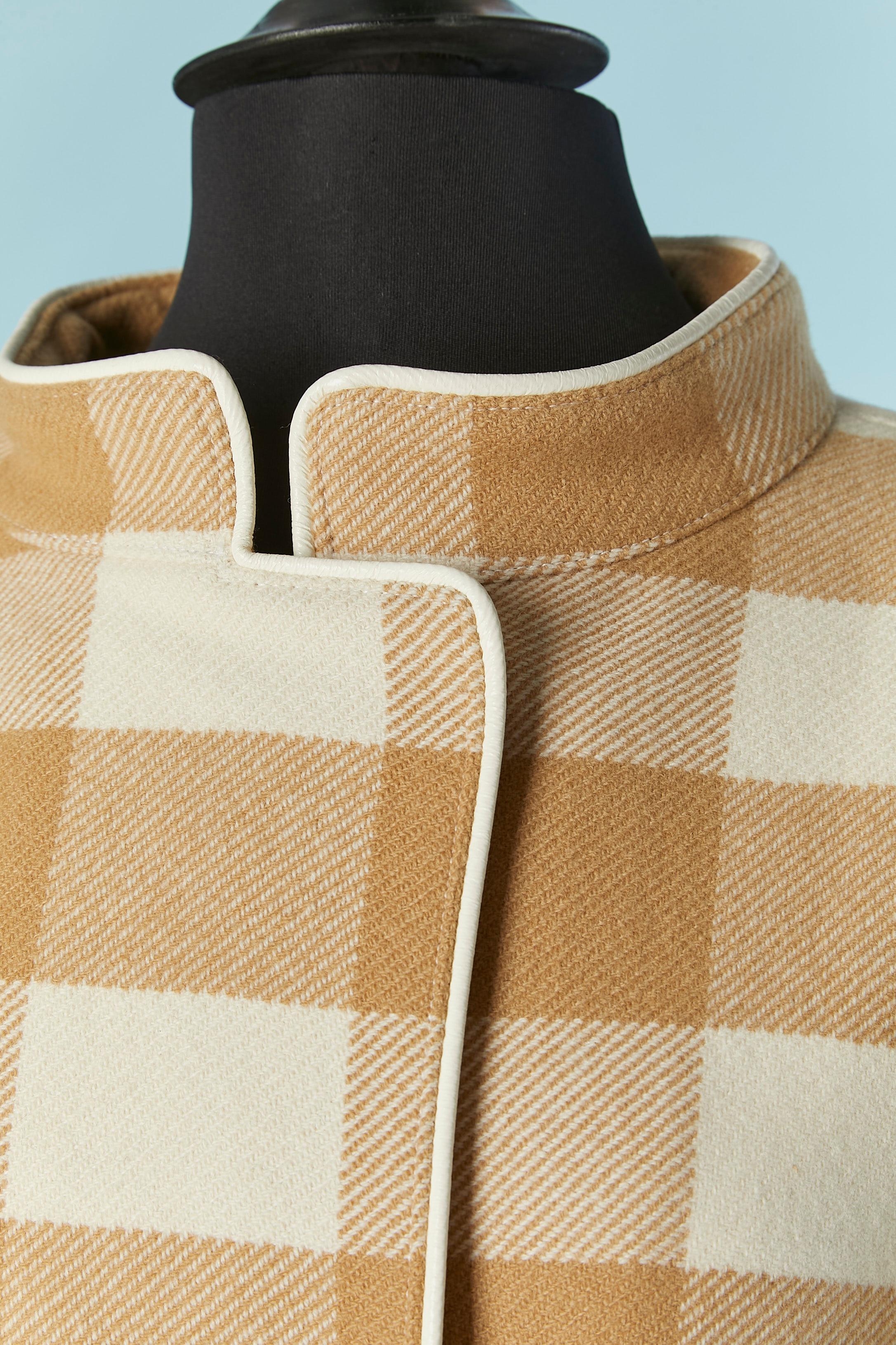 Beige and off-white wool double breasted jacket with check pattern and white vinyl piping. Branded lining composition: acetate and cupro. Magnet snap closure. 
Shoulder pad. Pocket on both side. 
SIZE 38 (Fr) M 