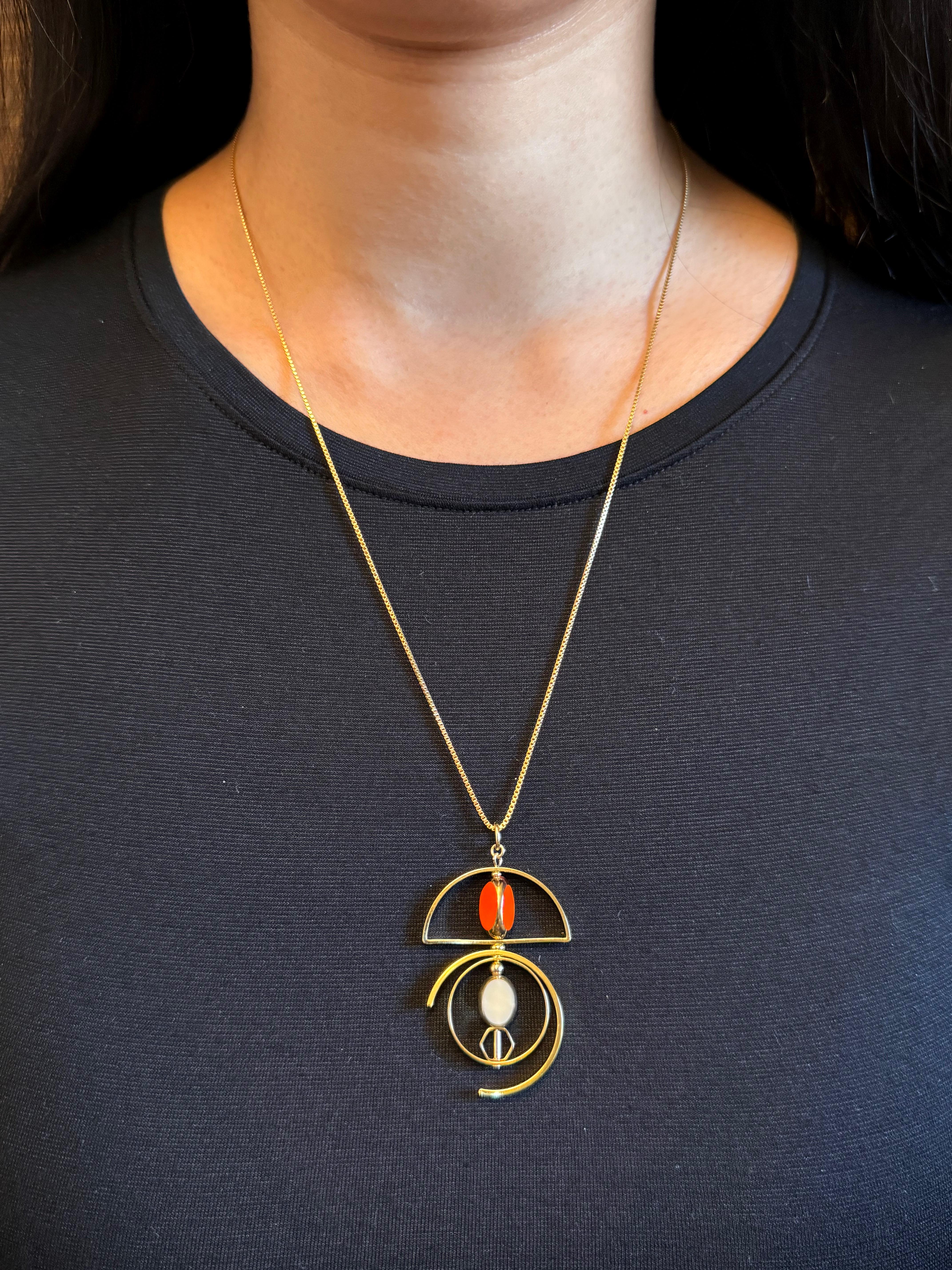 The pendant consists of beige and orange vintage German glass beads and is finished with a 22-inch gold-filled chain. 

The beads are new old stock vintage German glass beads that are framed with 24K gold. The beads were hand-pressed during the