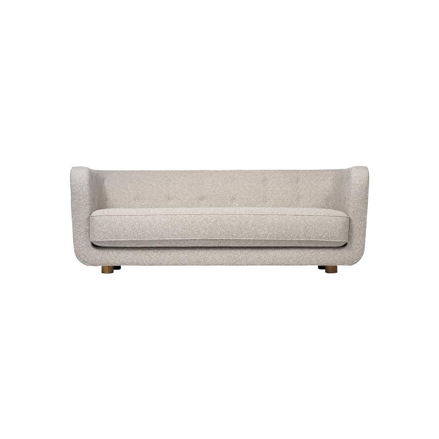Beige and smoked oak sahco nara vilhelm sofa by Lassen.
Dimensions: W 217 x D 88 x H 80 cm 
Materials: Textile, oak.

Vilhelm is a beautiful padded three-seater sofa designed by Flemming Lassen in 1935. A sofa must be able to function in several
