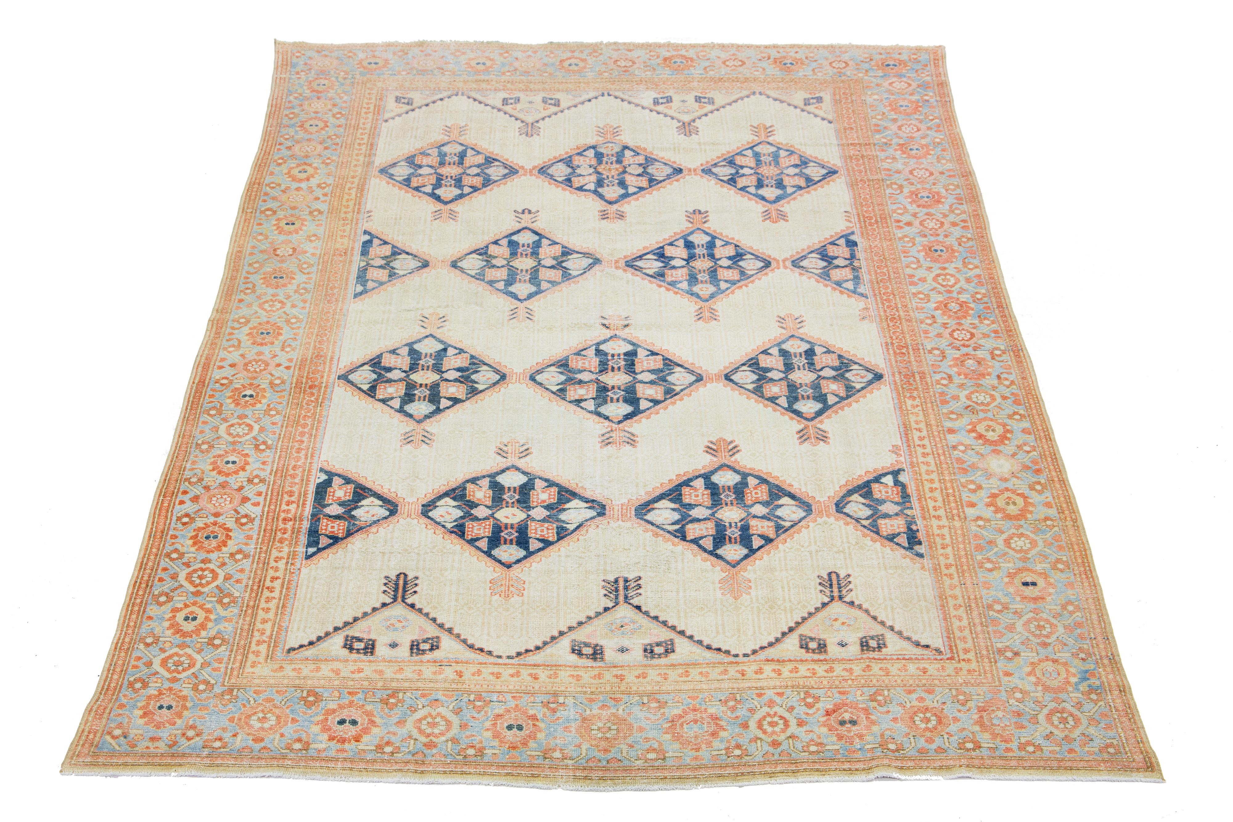 This exquisite antique Hamadan rug is hand-knotted from premium wool, boasting a beige field complemented by a captivating, tribal pattern design enriched with blue and orange accents.

This rug measures 8'3