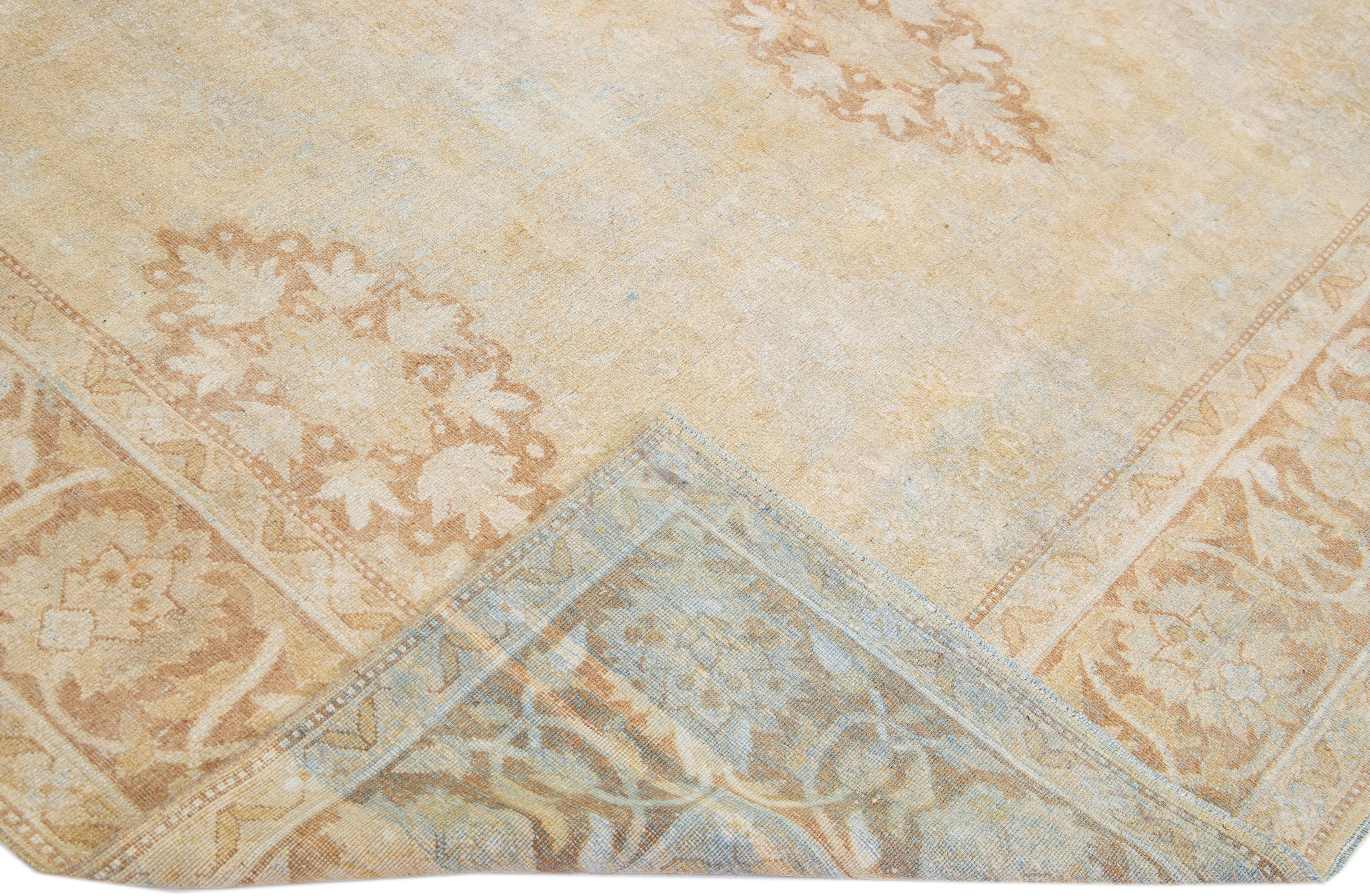 Beautiful antique Agra hand-knotted wool rug with a beige color field. This Indian rug has brown and blue accents in a gorgeous floral pattern design.

This rug measures: 9'7