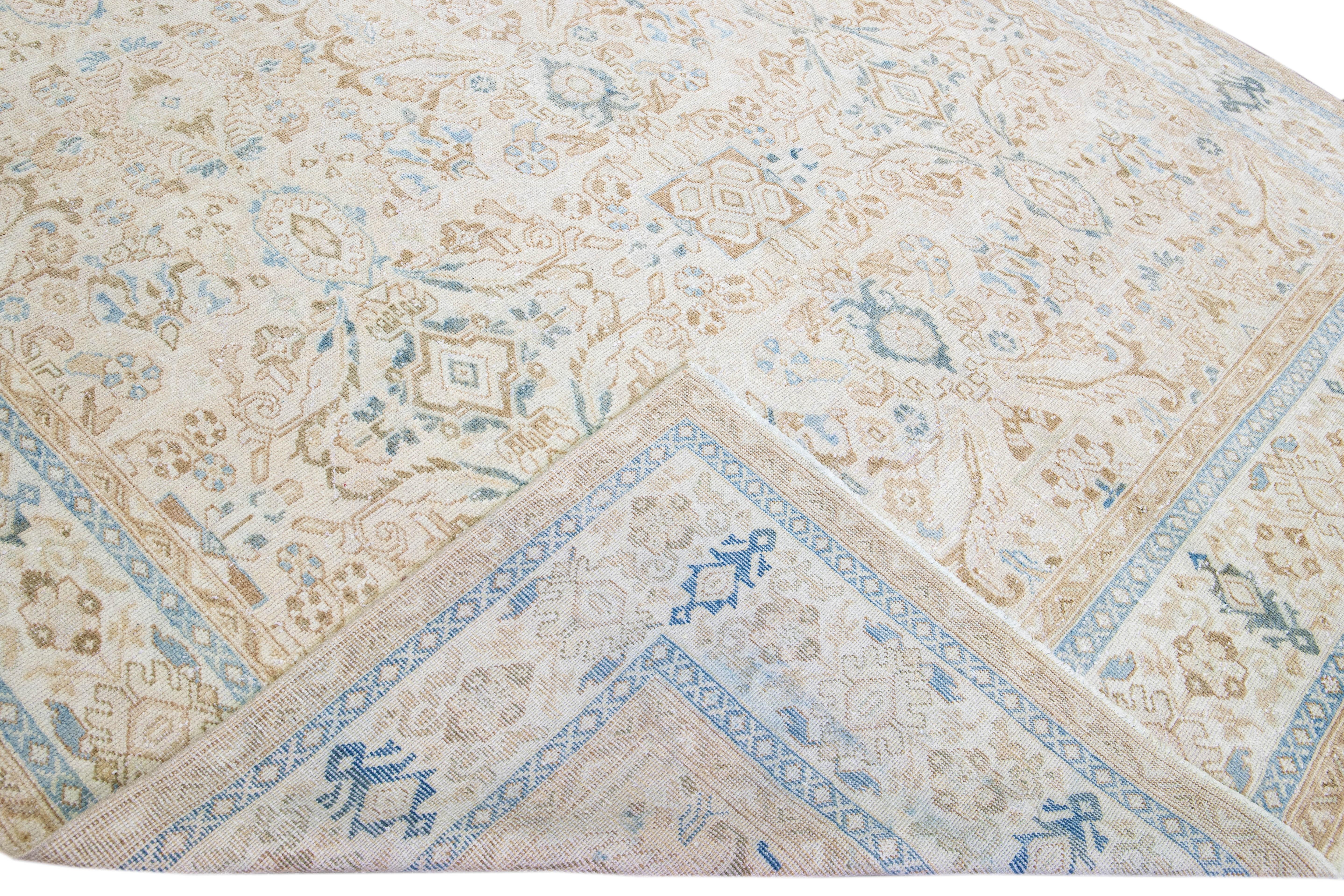 Beautiful hand-knotted antique Mahal wool rug with the Beige field. This Persian rug has blue and tan accents featuring a traditional floral pattern design. 

This rug measures 9'3