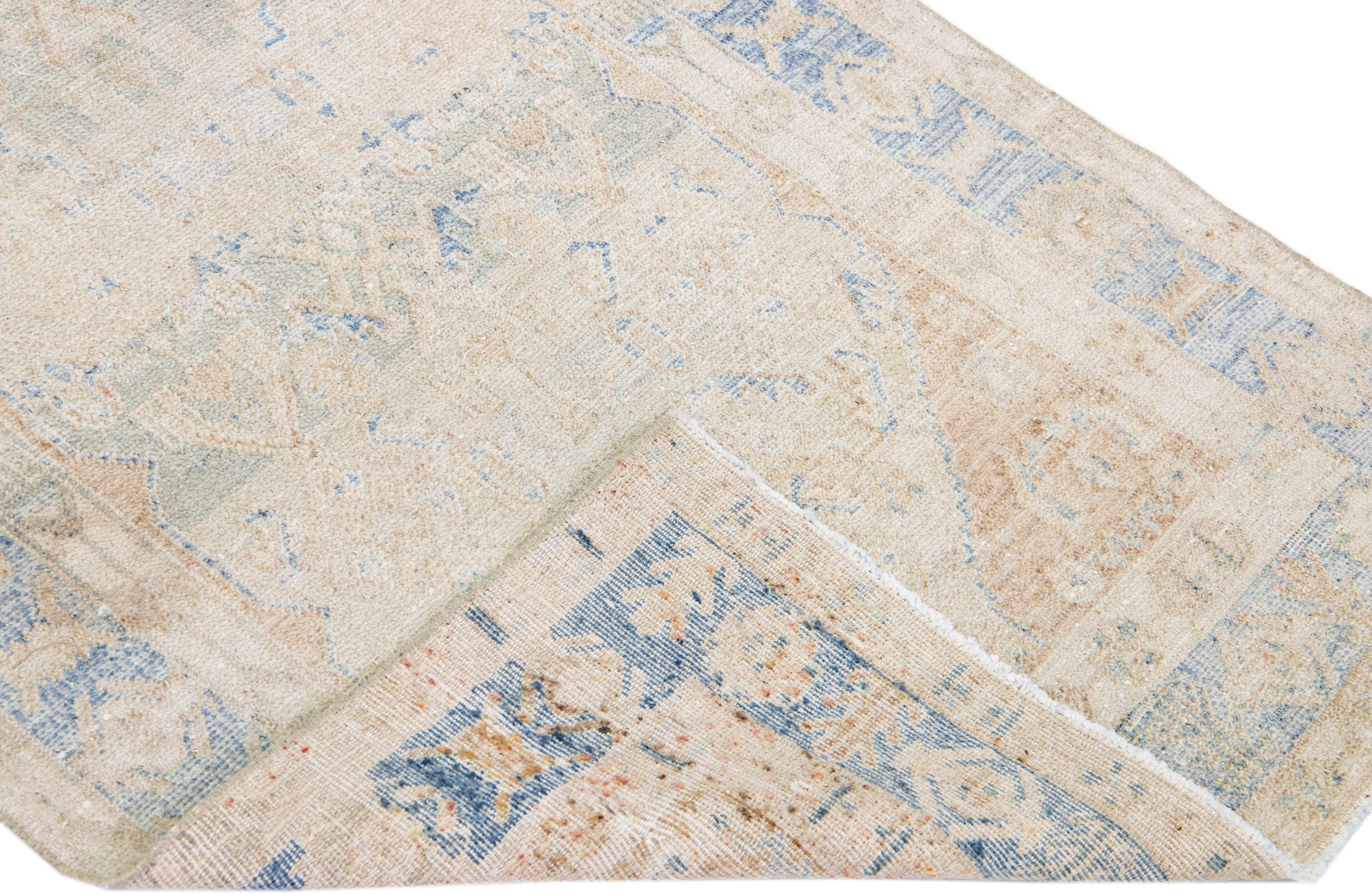 Beautiful antique Heriz hand-knotted wool runner with a beige and blue field. This Persian rug has a blue frame and accents in a gorgeous allover pattern design.

This rug measures: 3'2