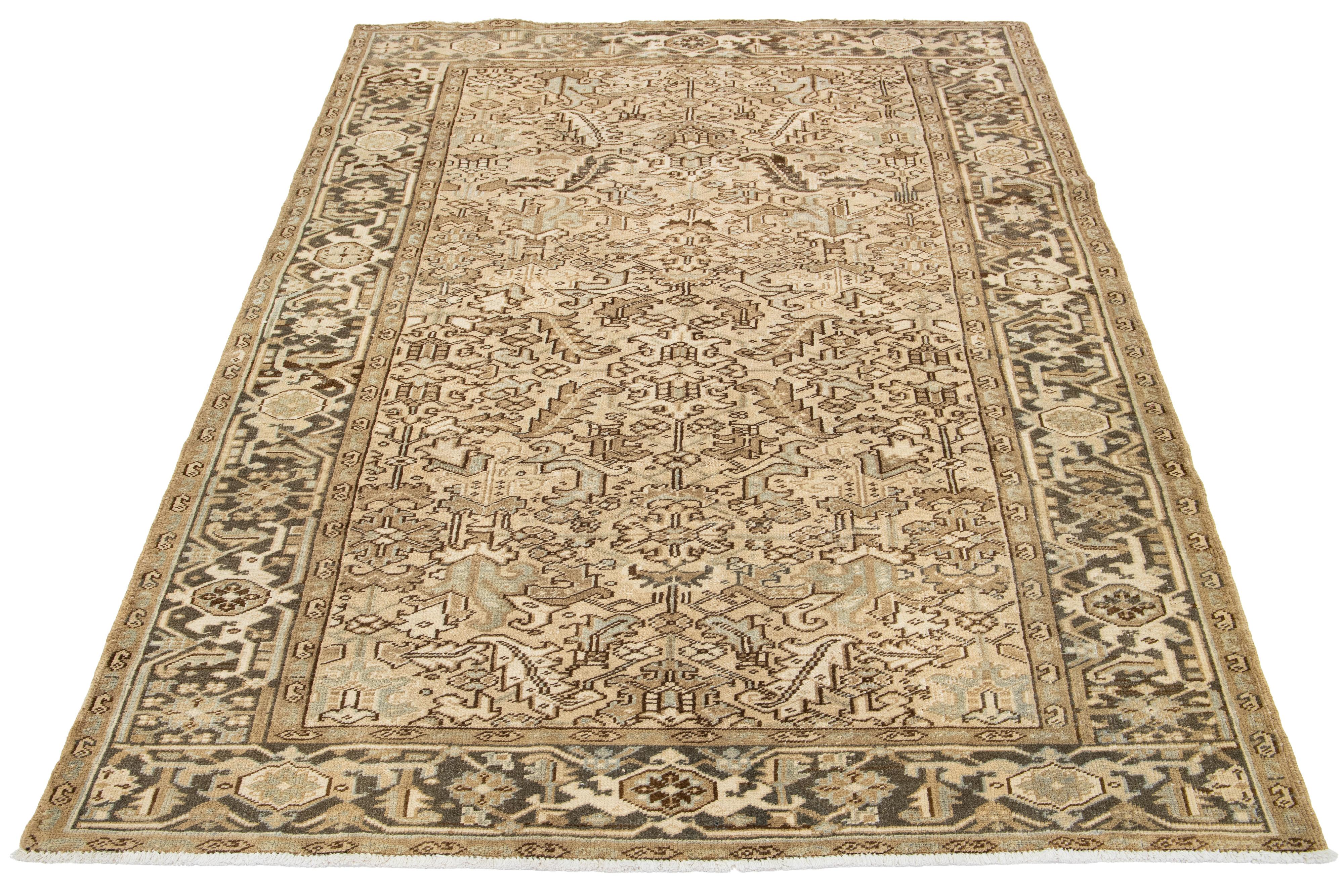 Antique Persian Heriz rug with blue and light brown all-over pattern on a beige field. Hand-knotted wool.

This rug measures 6'9' x 9'8