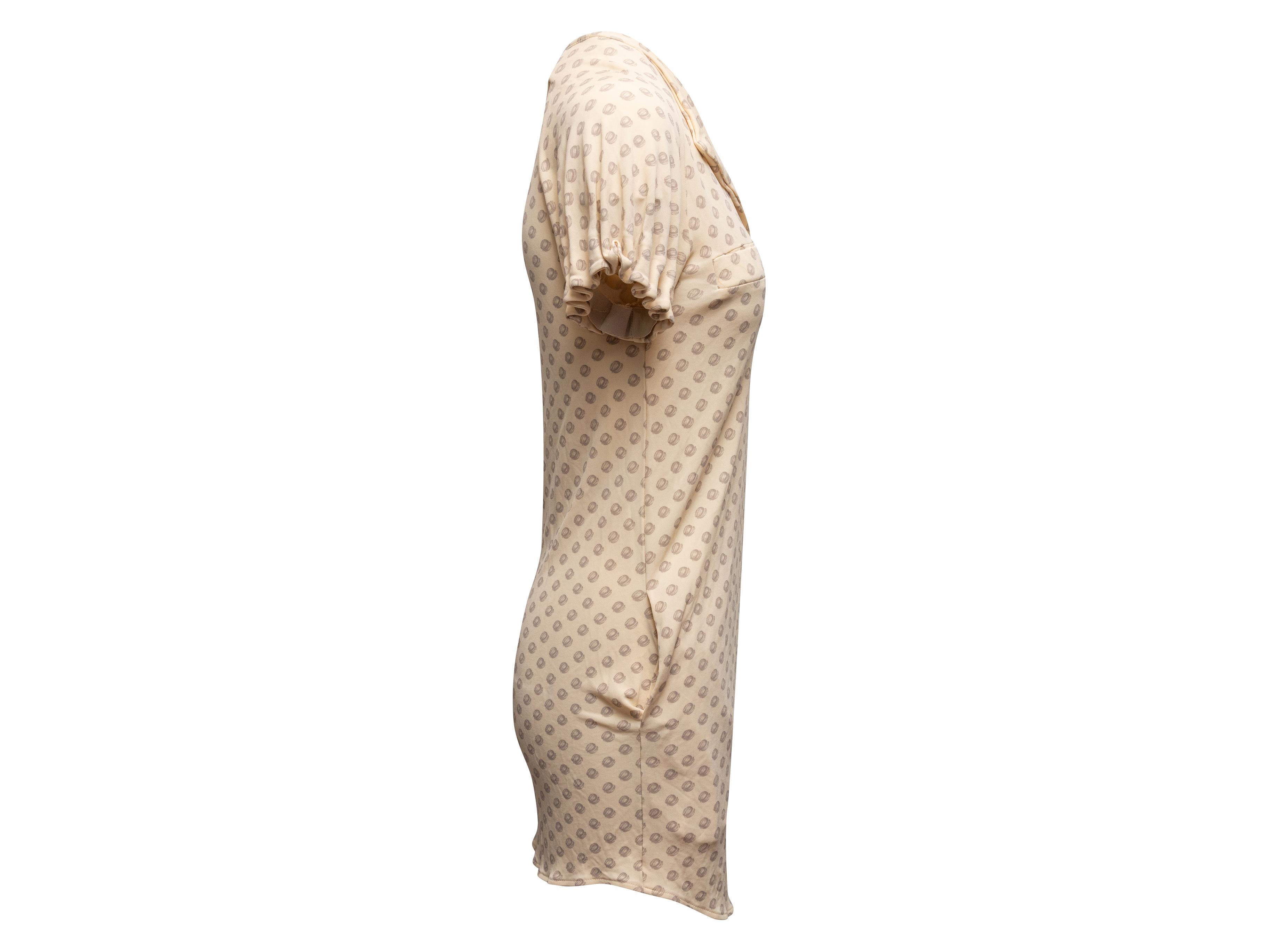 Beige short sleeve printed mini dress by Balenciaga. V-neck. Dual bust and hip pockets. 32