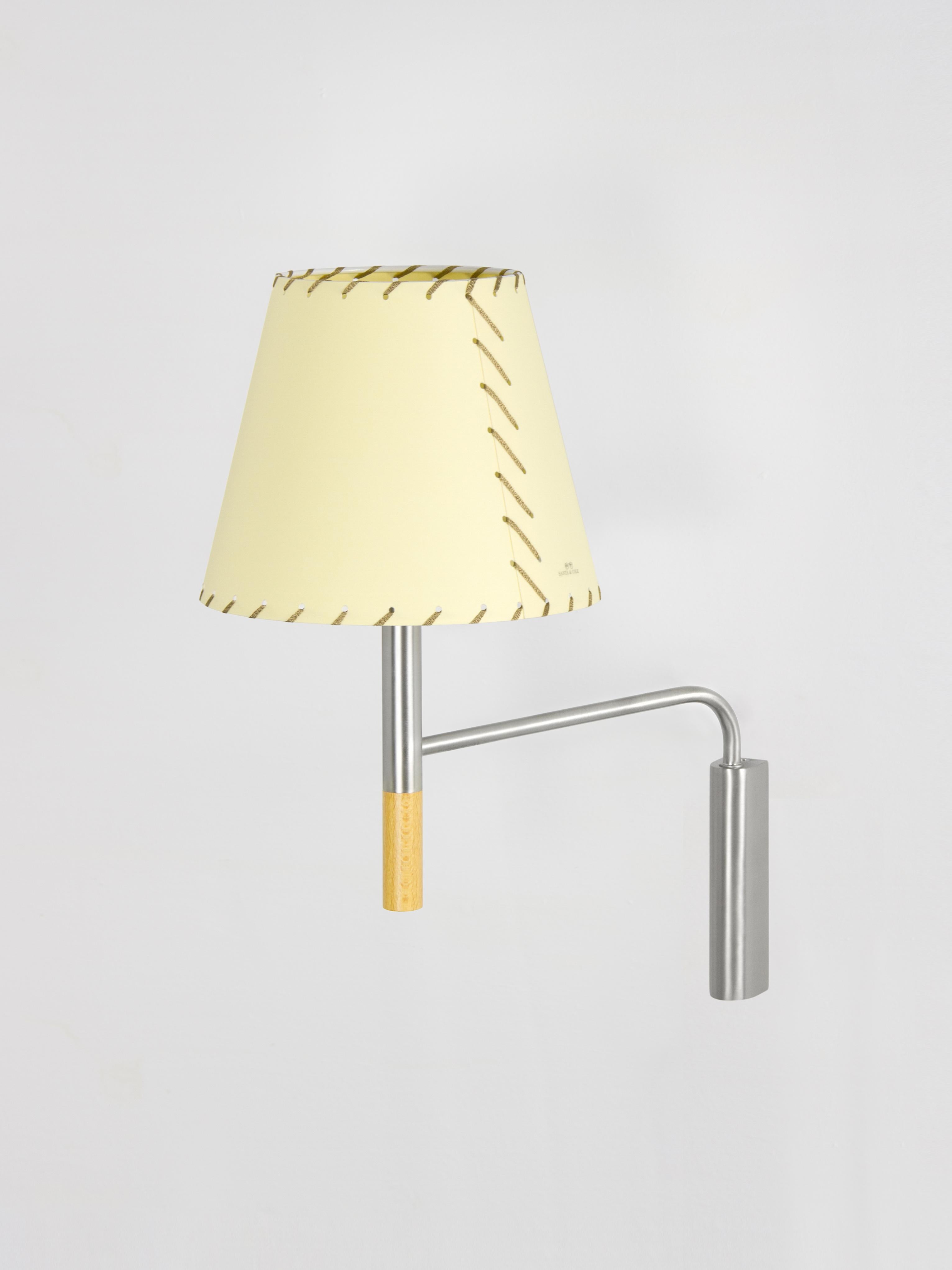 Beige BC3 wall lamp by Santa & Cole
Dimensions: D 20 x W 37 x H 41 cm
Materials: Metal, beech wood, stitched parchment.

The BC1, BC2 and BC3 wall lamps are the epitome of sturdy construction, aesthetic sobriety and functional quality. Their