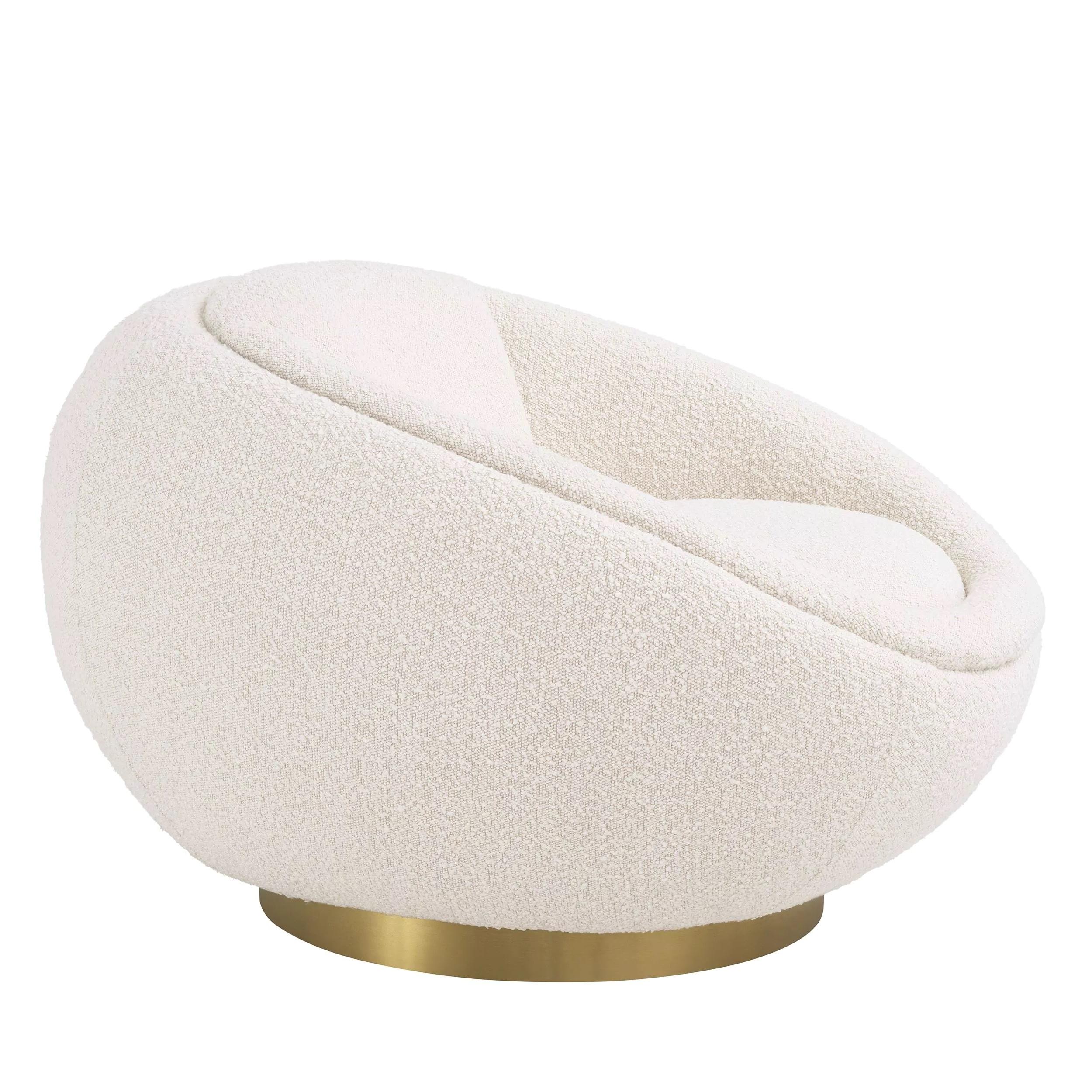 Welcoming and round shaped swivel armchair in beige bouclé fabric with brass finishes.