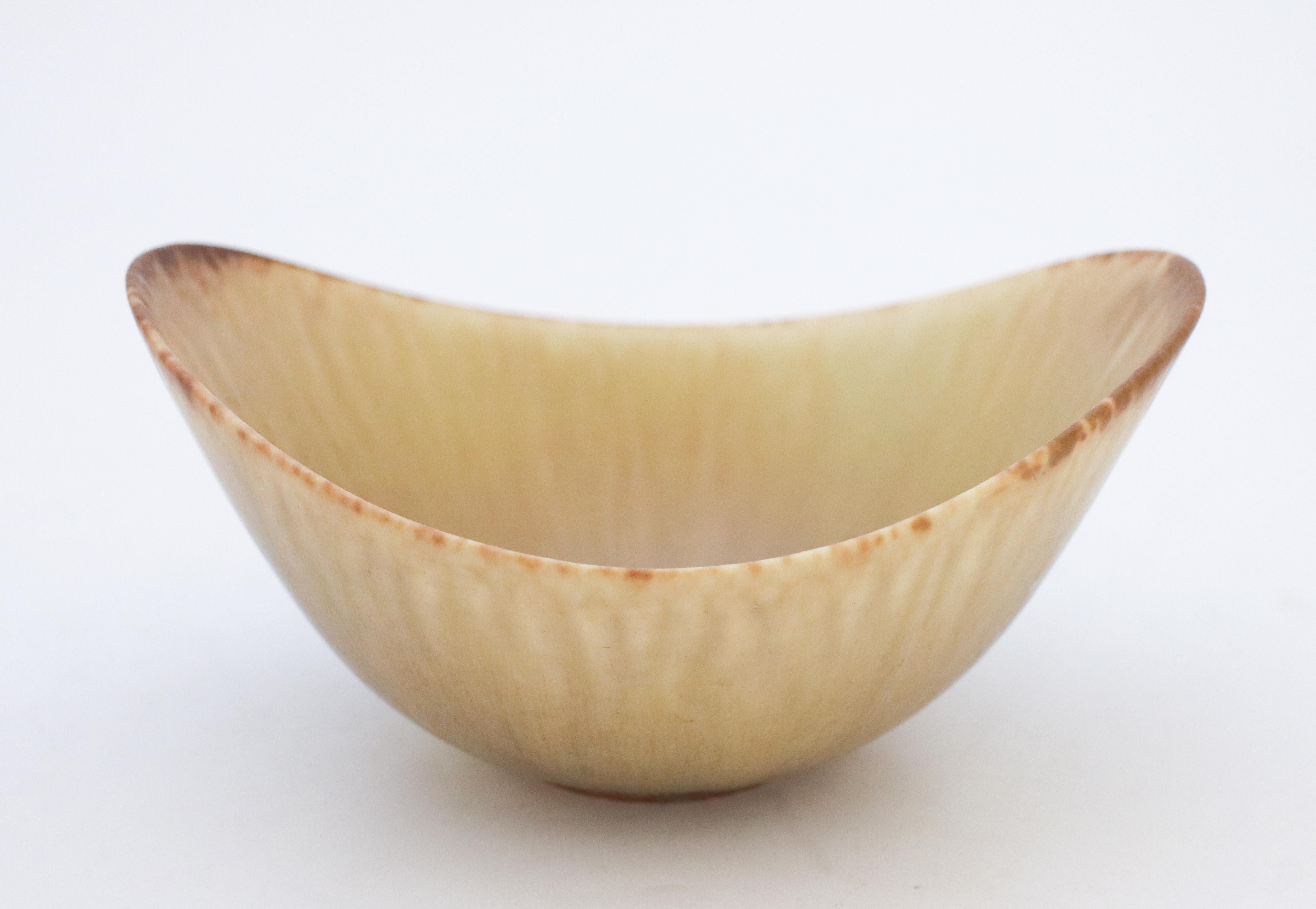 A beige bowl designed by Gunnar Nylund at Rörstrand, the bowl is 8 cm (3.2