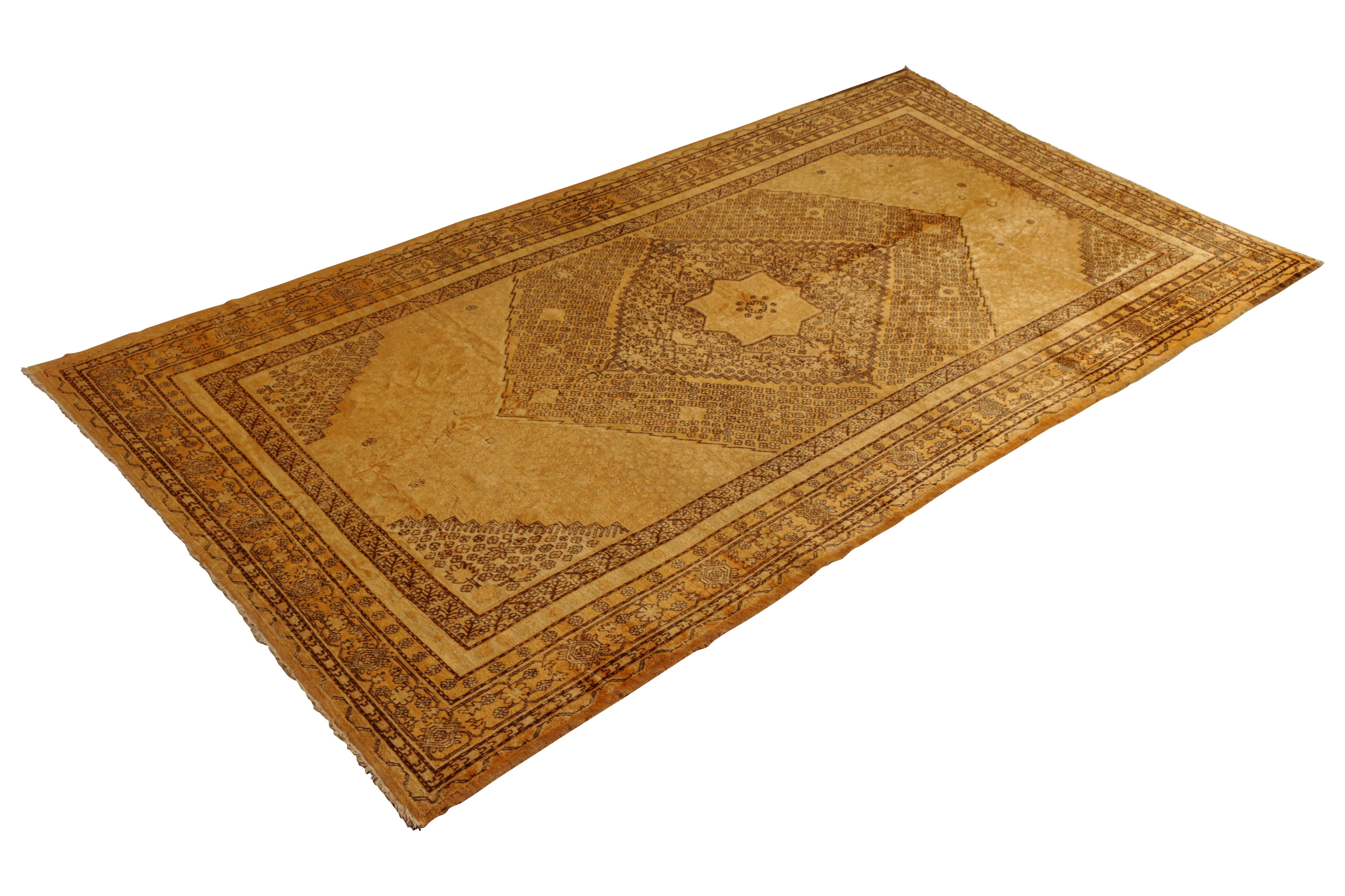 Hand knotted in wool originating from East Turkestan circa 1890-1900, this antique rug connotes a classic Khotan rug design with a Classic approach to transitional colorway celebrated in this Oriental rug family. The spacious 6’9 x 12’6 size and the