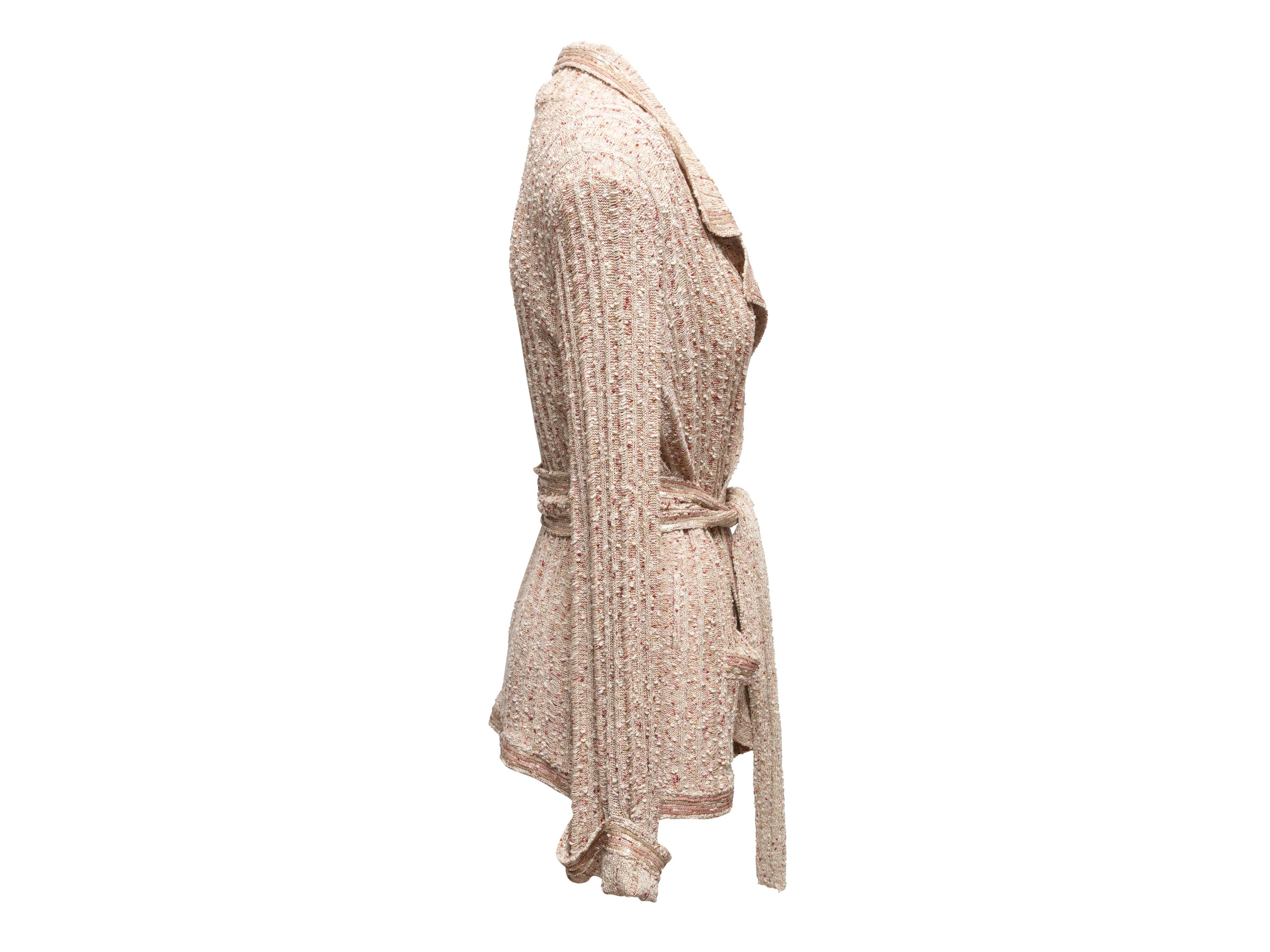  Beige boucle knit jacket by Chanel. From the Spring/Summer 2006 Collection. Notched collar. Dual hip pockets. Sequin trim throughout. Sash tie closure at waist. 40