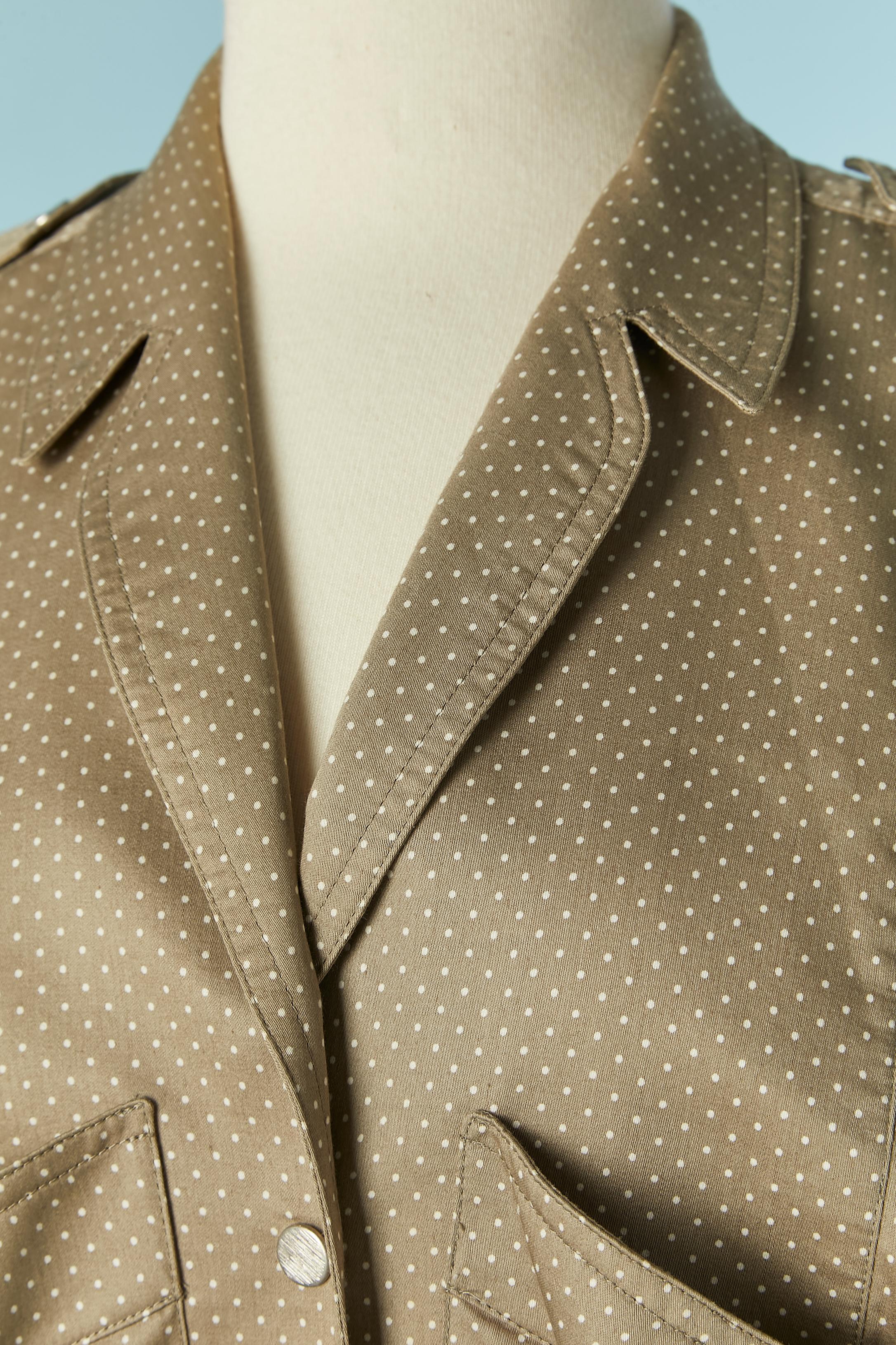 Beige cotton dress with white Polka dot print. Fabric belt tied on the middle front. Snap closure. Pocket on both side on the breast . Gather on the middle front. 
SIZE L 