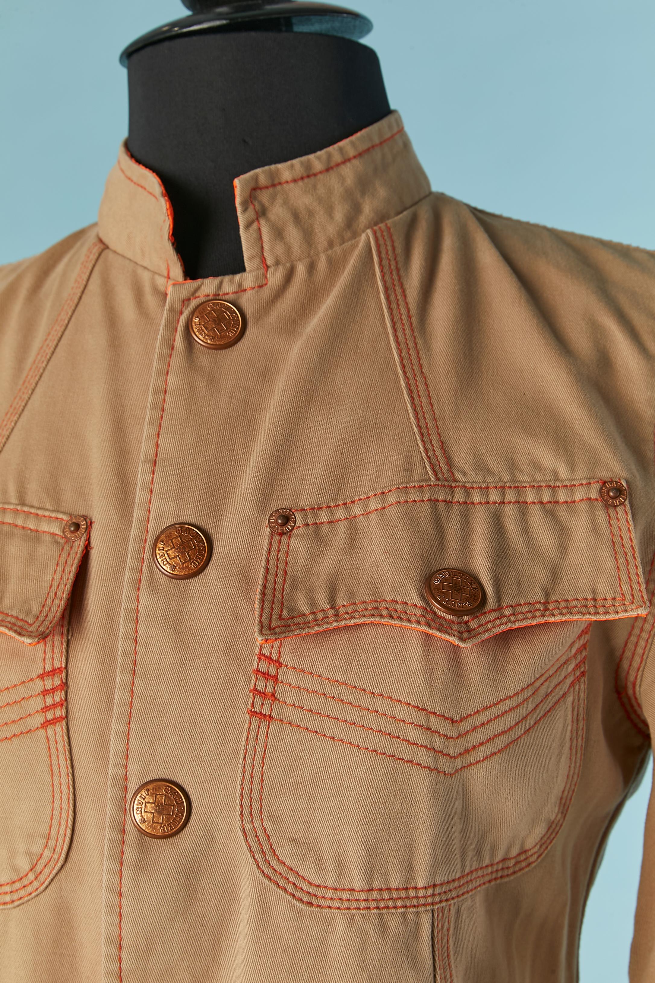 Beige cotton officer jacket with orange topstitching. Orange nylon lining ( only on the shoulders) 
Branded snap closure on the middle front and on pockets. Branded studs. 
SIZE S