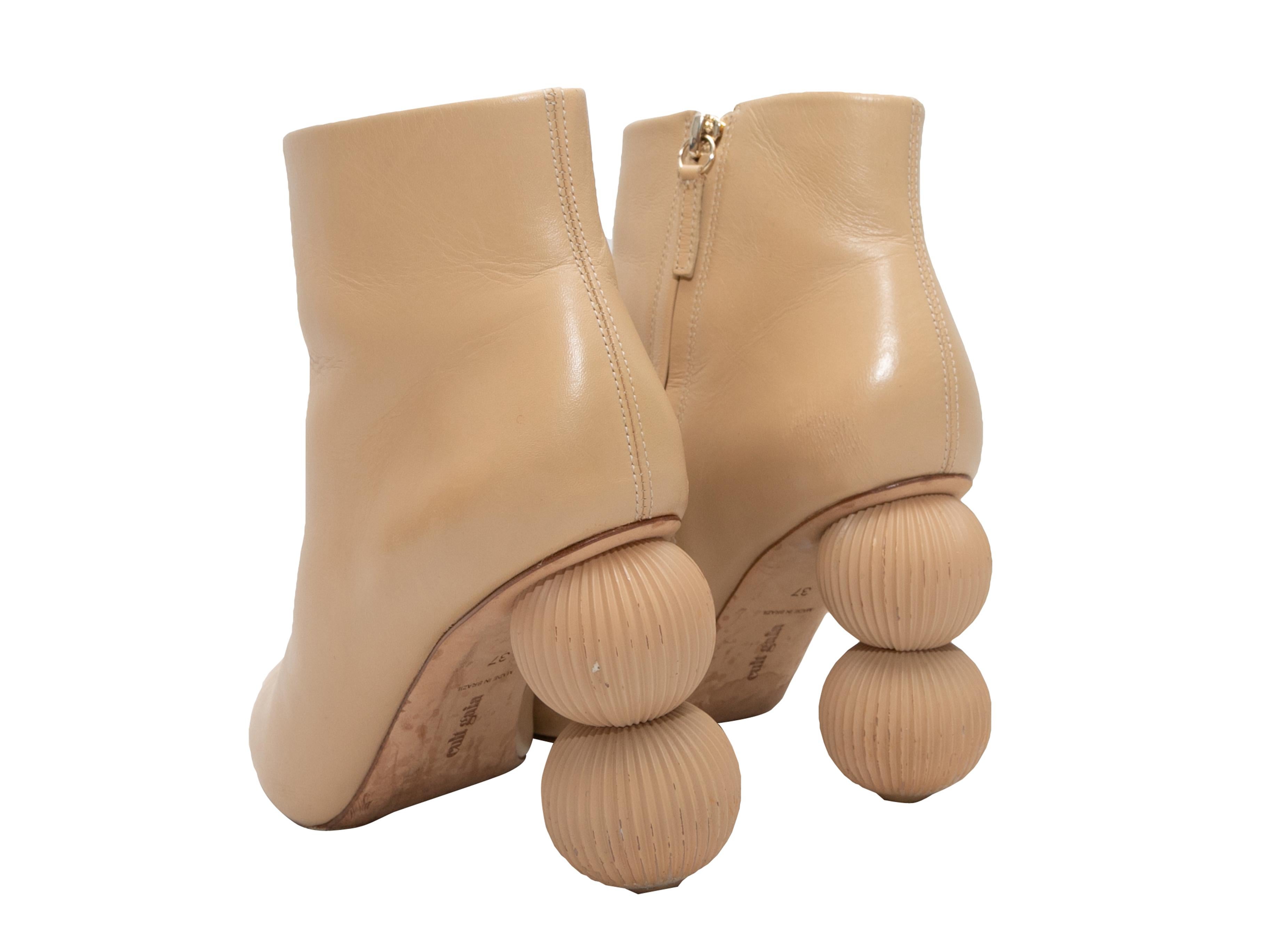 Beige leather pointed-toe Cam Bauble ankle boots by Cult Gaia. Zip closures at inner sides. 4.25