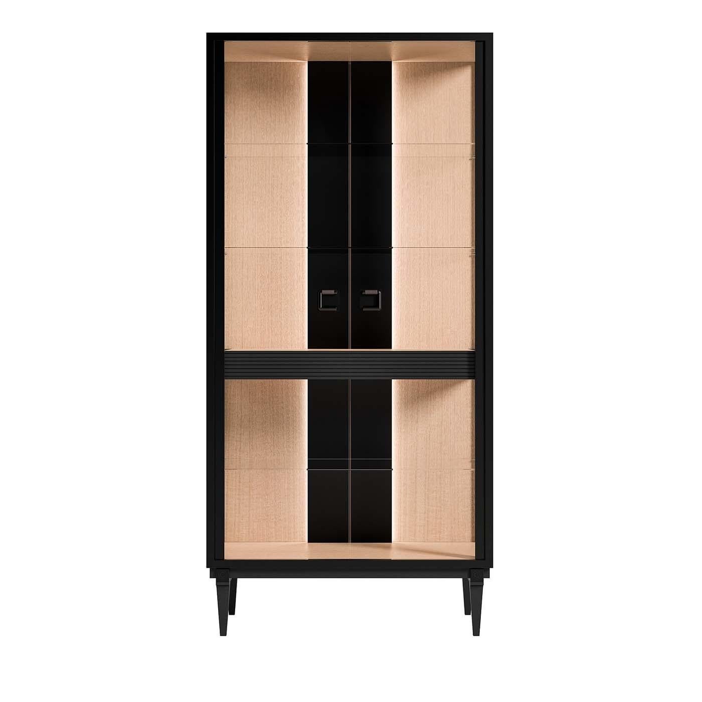 Defined by formal balance and modern aesthetic, this display cabinet revisits a midcentury design with a modern sensibility. Both elegant and functional, this piece has a eucalyptus-veneered frame raised on four tapered feet with a black finish. The