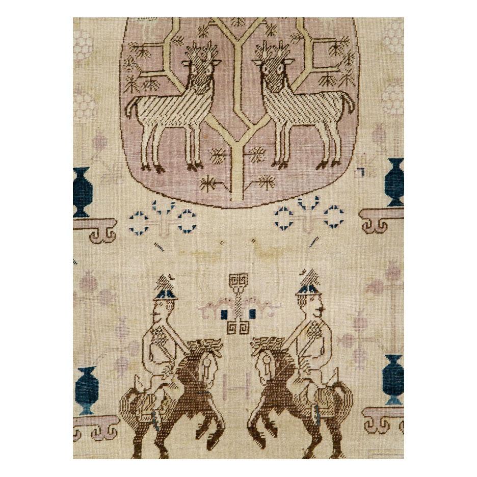 An antique East Turkestan Khotan room size carpet in gallery format handmade during the early 20th century with a pictorial design predominantly in beige/cream.

Measures: 7' 2