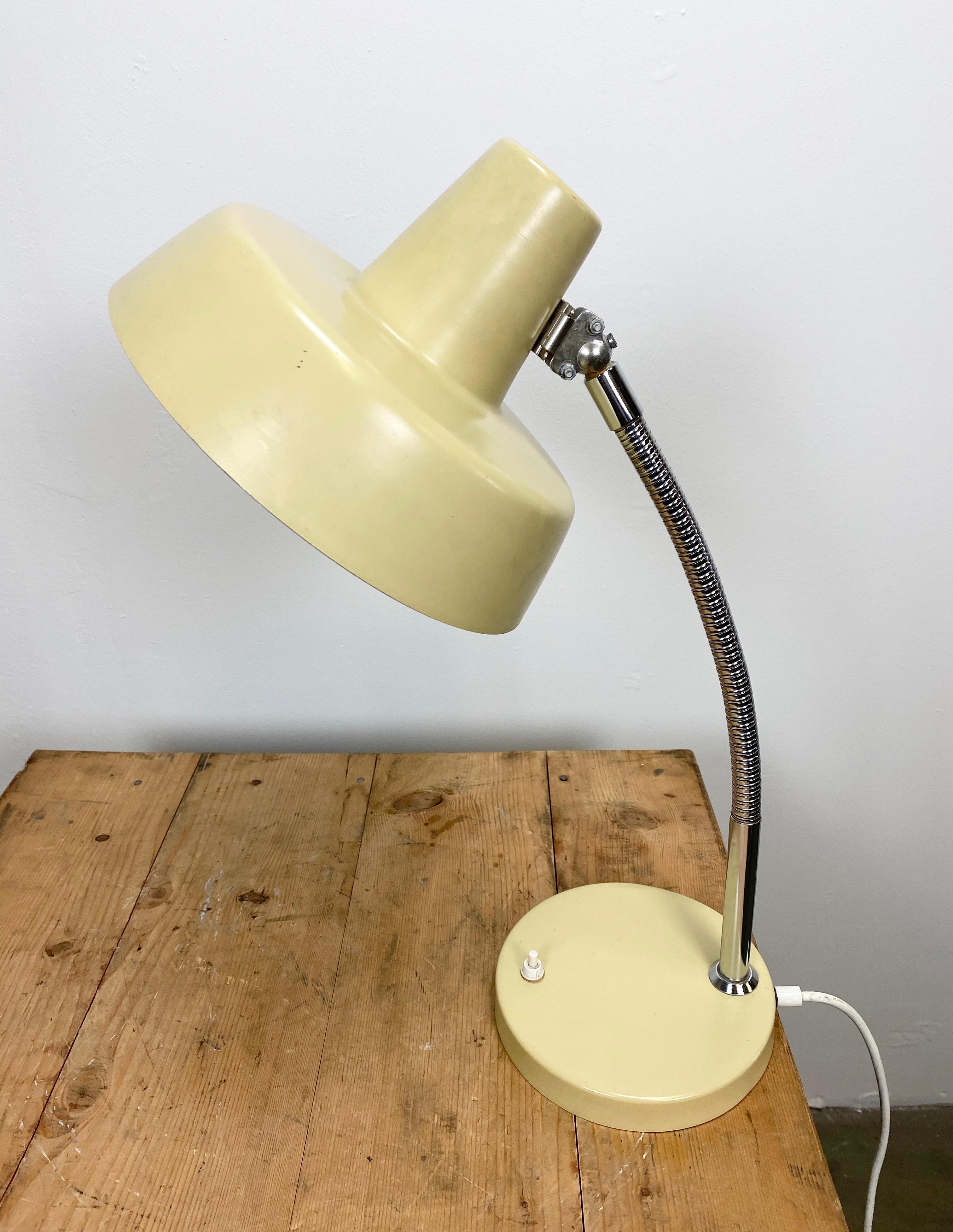This desk lamp from the 1960s was designed and manufactured in former Czechoslovakia. It features a chrome-plated flexible arm, beige metal base and shade. The socket for E 27 lightbulbs. Fully functional. Original vintage condition.
Diameter of