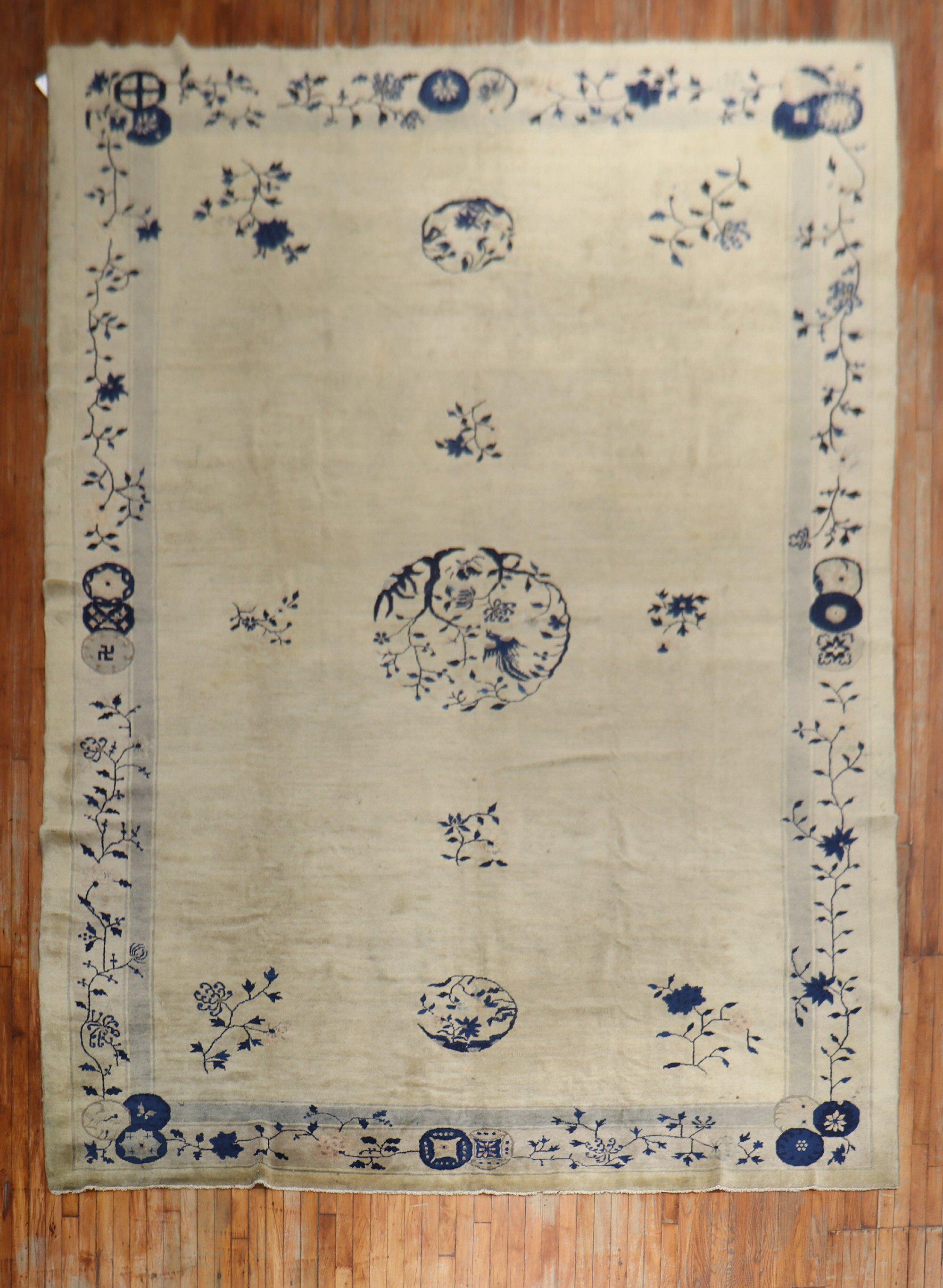 An early-20th-century room size Chinese rug in the navy, beige, and gray color family. The wool and feel of the rug is very soft on the feet. It has a silky sheen to it as well.

Measures: 9'3'' x 14'3''.