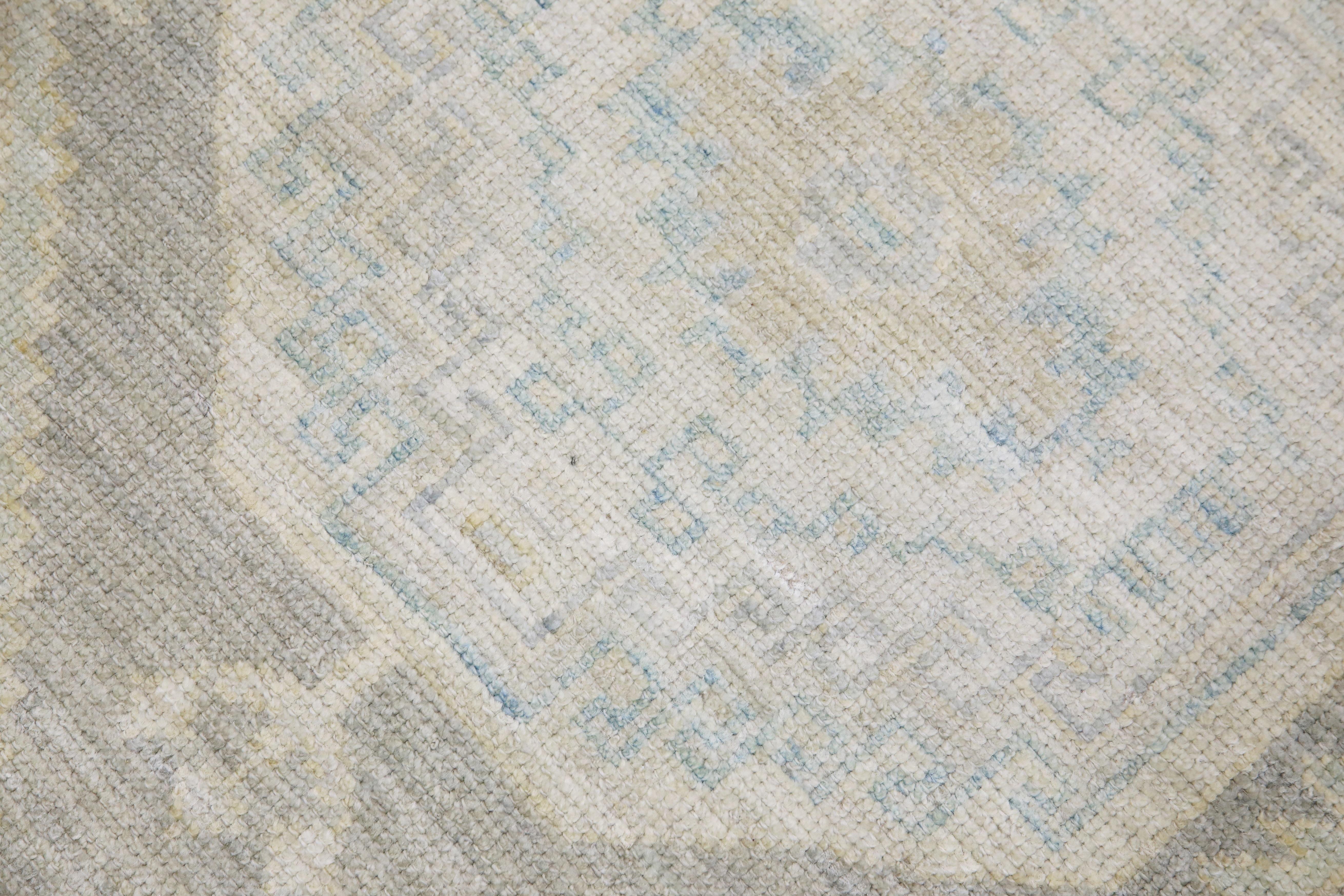 This modern Turkish Oushak rug is a stunning piece of art that has been handwoven using traditional techniques by skilled artisans. The rug features intricate patterns and a soft color palette that is achieved through the use of natural vegetable