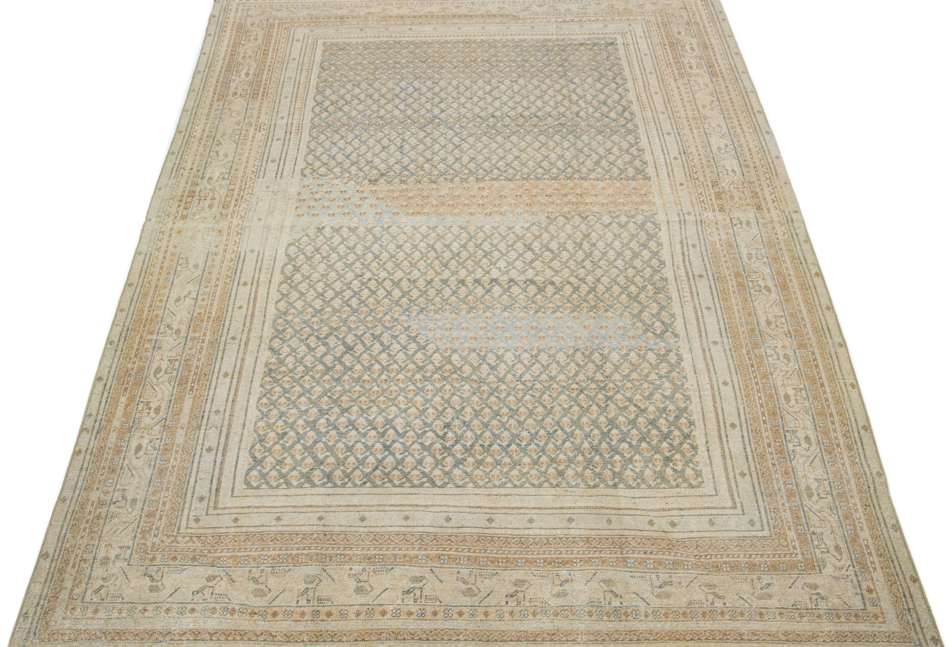 This exquisite antique Hamadan rug is hand knotted from premium wool, boasting a beige field complemented by a captivating, all-over pattern design enriched with brown and blue accents.

This rug measures 6'4