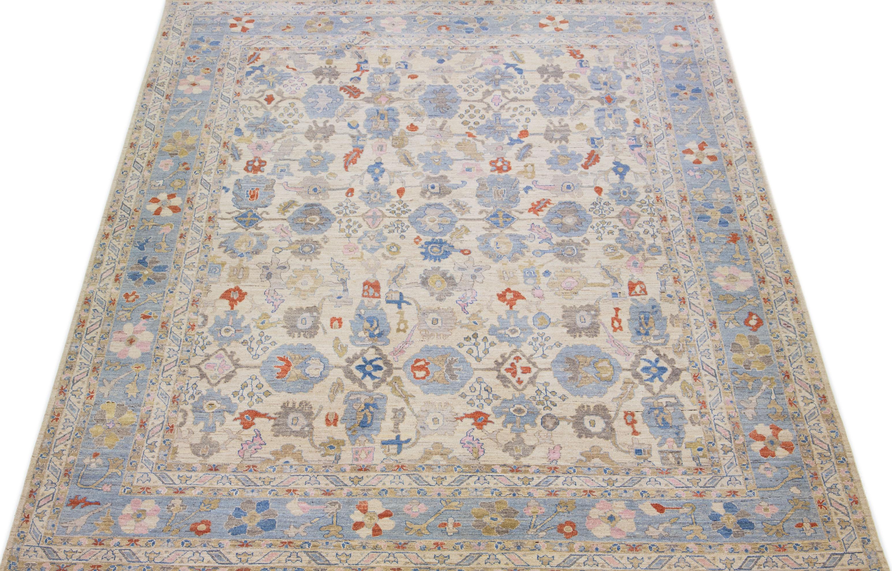 This hand-knotted wool rug showcases an exquisite modern Oversize Sultanabad design in a stunning beige color palette. Its intricate blue frame features beautiful accents in rust, blue, and pink hues arranged in a remarkable all-over pattern.

This