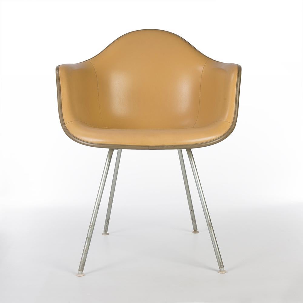 A nicely finished all original Eames DAX arm shell chair for Herman Miller is completed by its Alexander Girard beige naugahyde vinyl, making the perfect chair. As an all original piece it does have some slight scuffs and marks but the vinyl cover