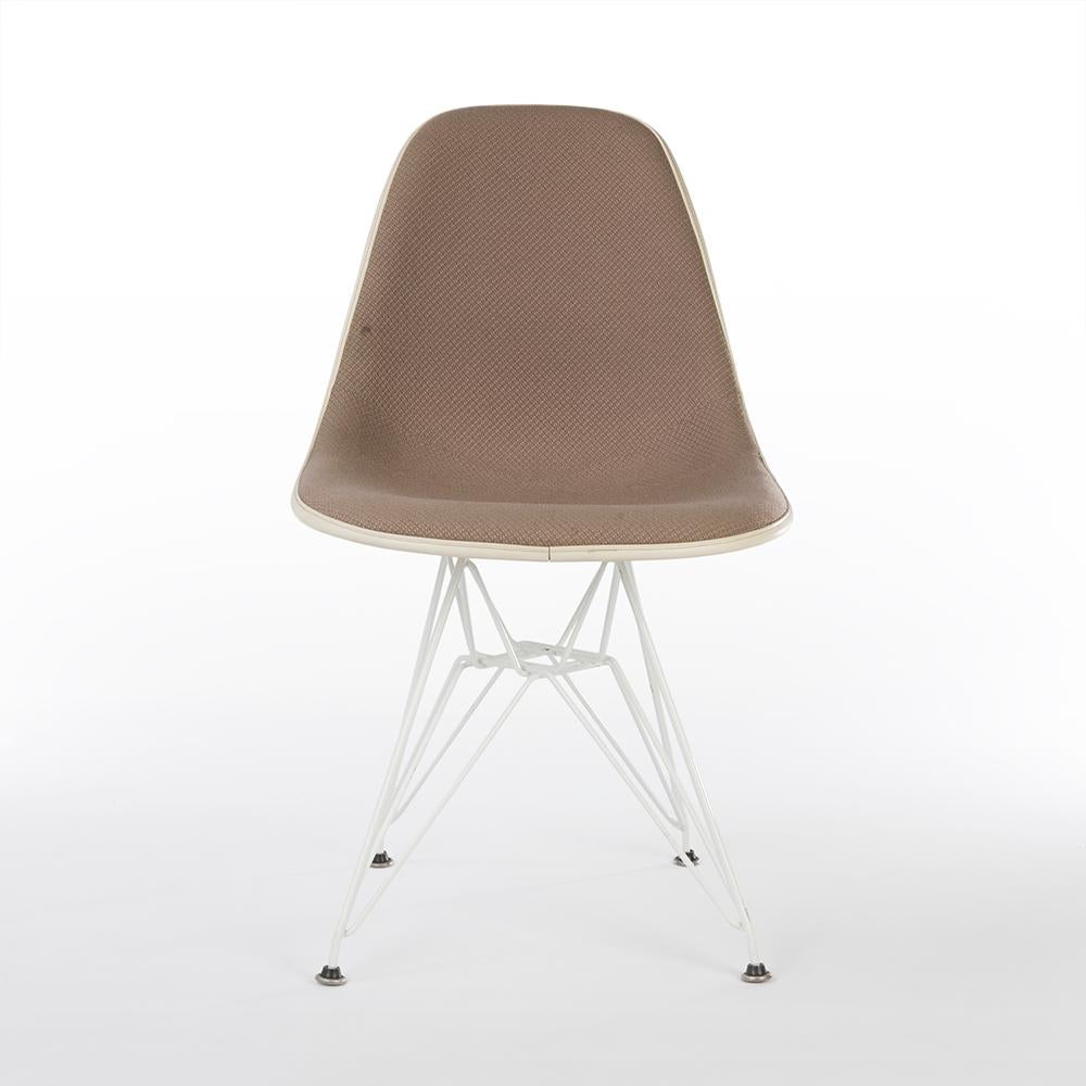 An original beige fabric Eames side shell by Herman Miller on a white newer, used, DSR Eiffel base creates the perfect combination for the iconic dining chair. Finished in a fabric designed by Alexander Girard himself which has a patterned,