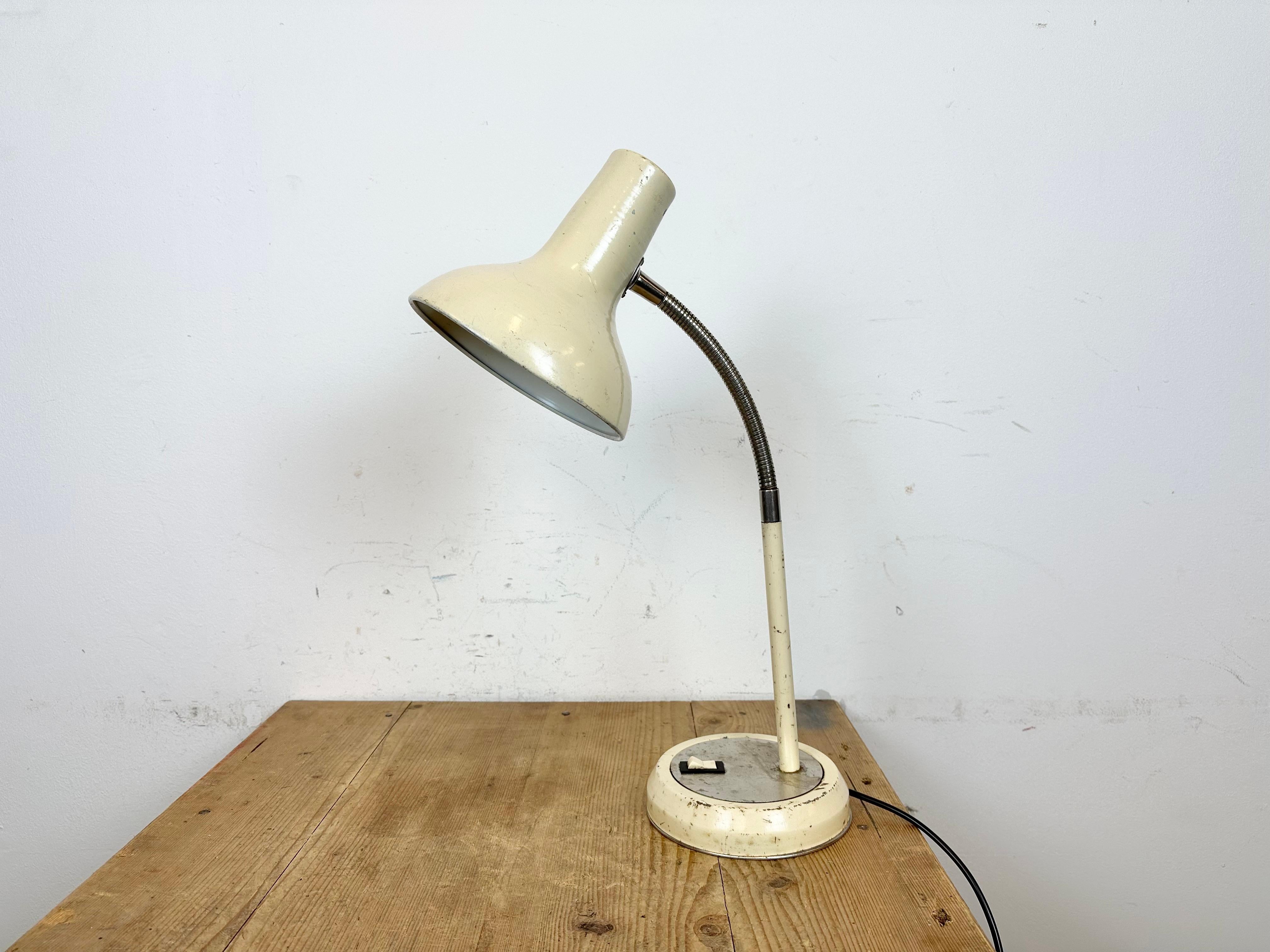 Industrial adjustable workshop table lamp made by Polam Wilkasy in Poland during the 1960s. It features an aluminium shade,a metal base with original switch and a chrome plated gooseneck. The original socket requires standard E27/E26 lightbulbs.
The
