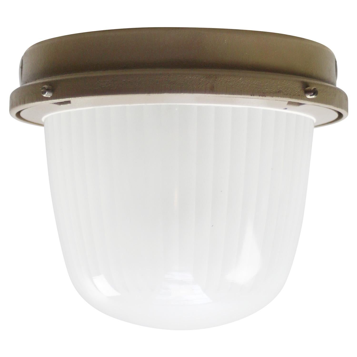 French Industrial wall / ceiling lamp by Holophane, France, model CE200
Beige cast iron with frosted cut glass.

Weight : 5.30 kg / 11.7 lb

Priced per individual item. All lamps have been made suitable by international standards for incandescent