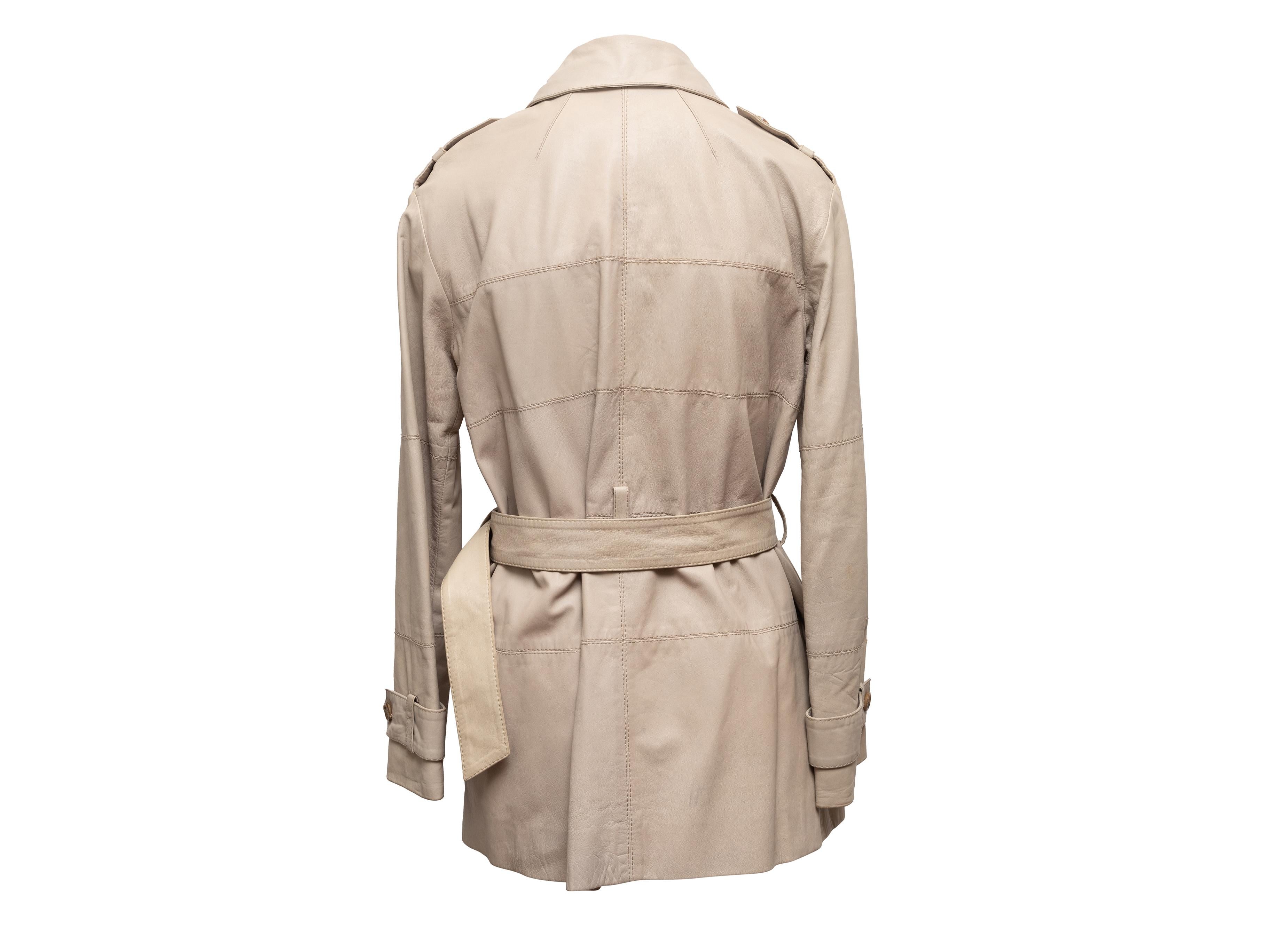 Beige lambskin leather trench coat by Louis Vuitton. Circa early 2000s. Pointed collar. Belt at waist. Button closures at center front. Designer size 38. 36