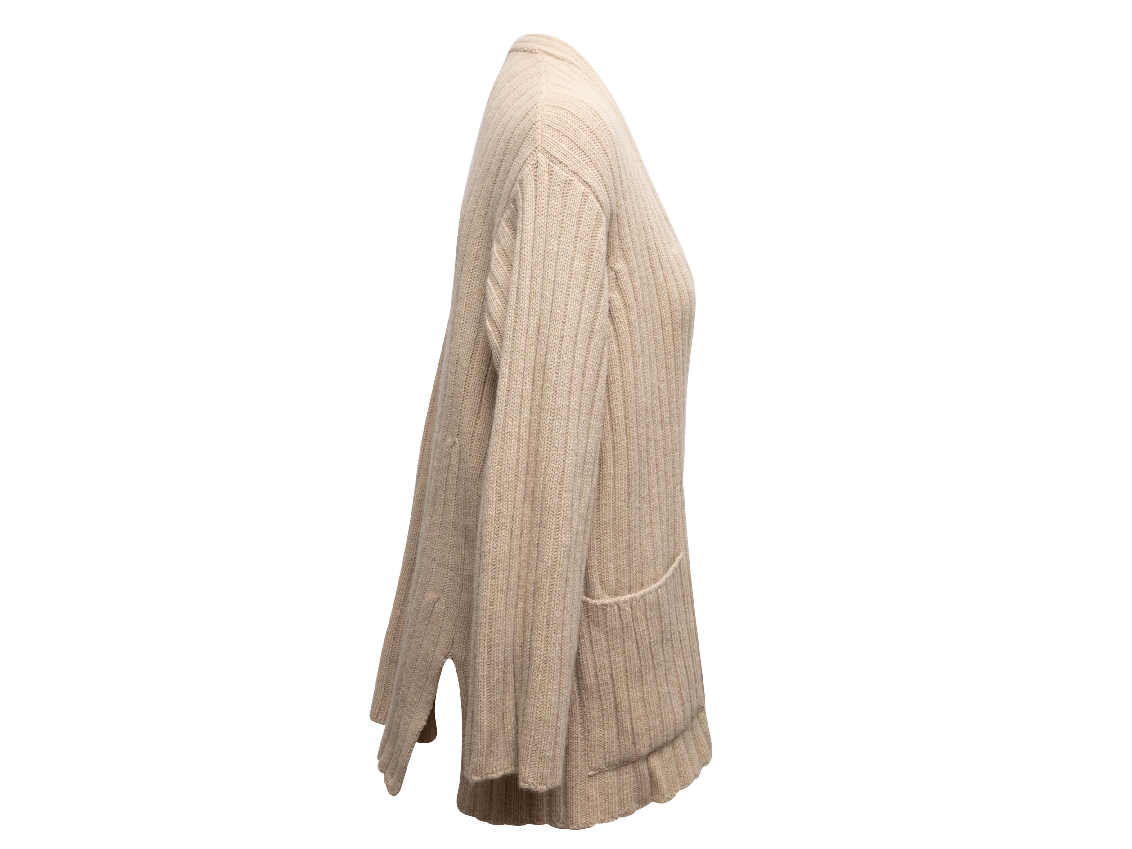 Beige rib knit cardigan by Max Mara. V-neck. Dual hip pockets. Single front button closure. 32