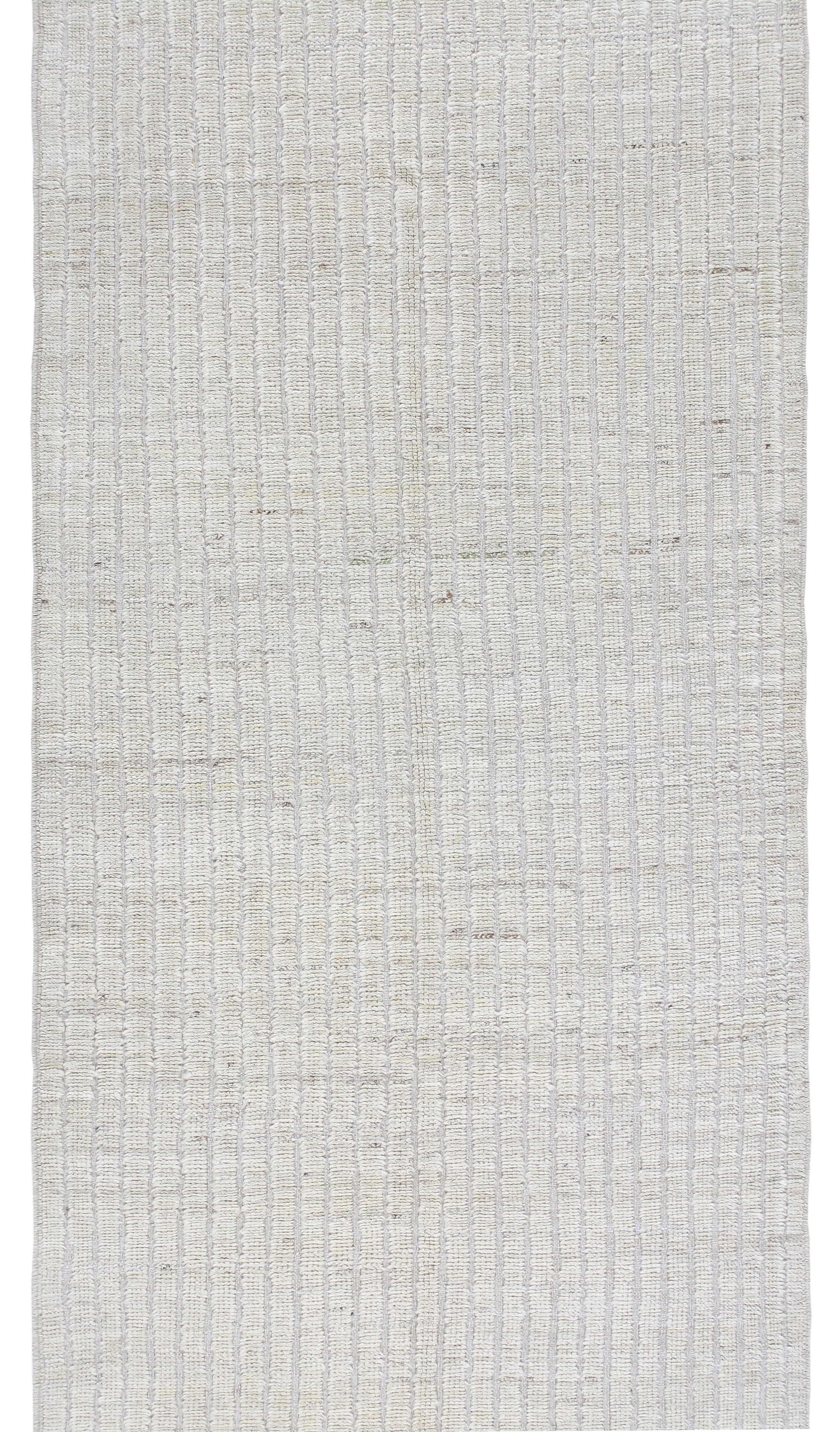 Our African runner is hand-knotted from the finest hand-carded, hand-spun, naturally dyed wool. This unique modern design was created using an ancient hand-knotting technique that involves skilled artisans tying individual knots onto the warp thread